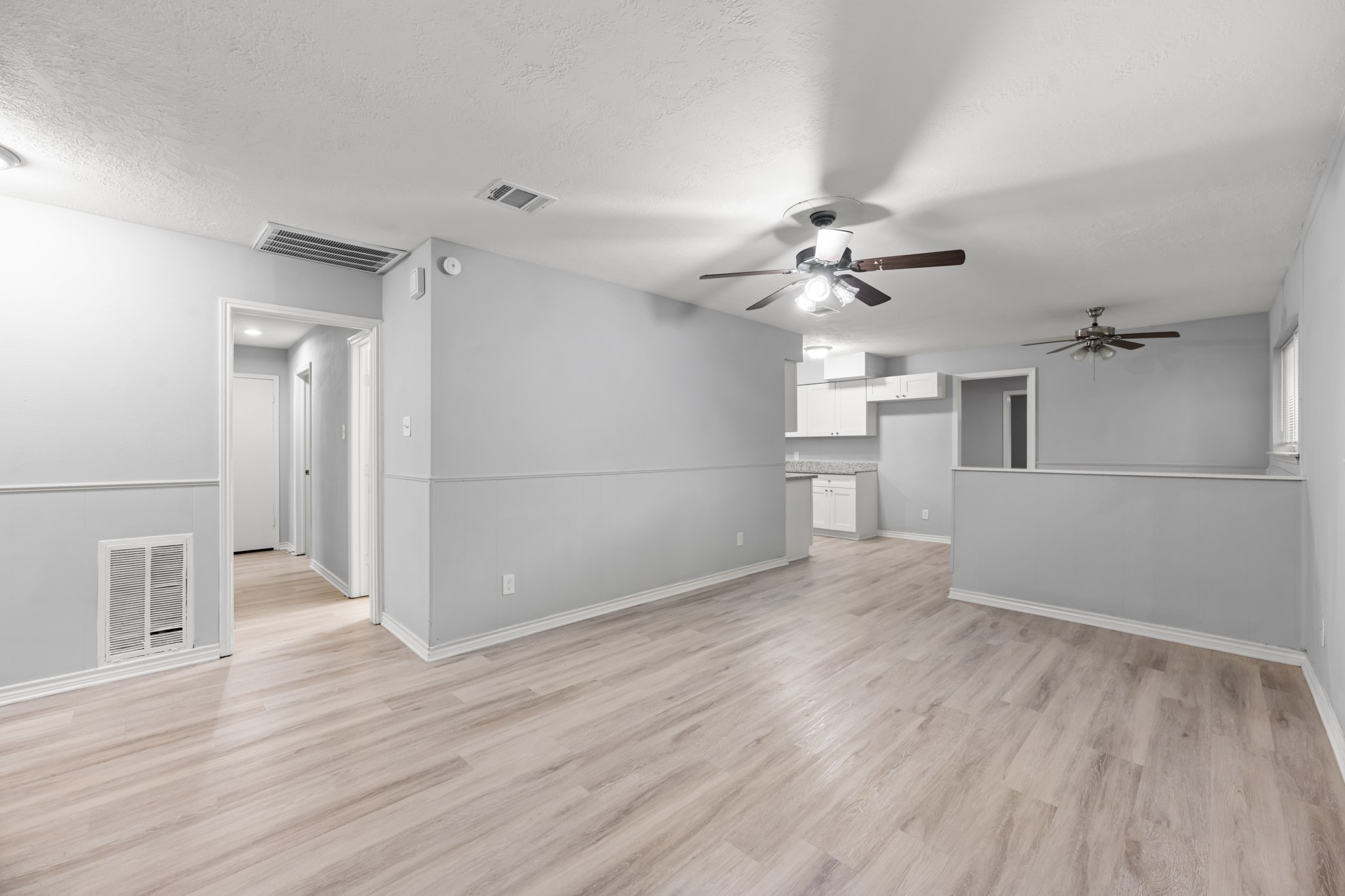 An open, flowing layout connects the living room to the kitchen and dining area, creating a versatile space for everyday living and entertaining.