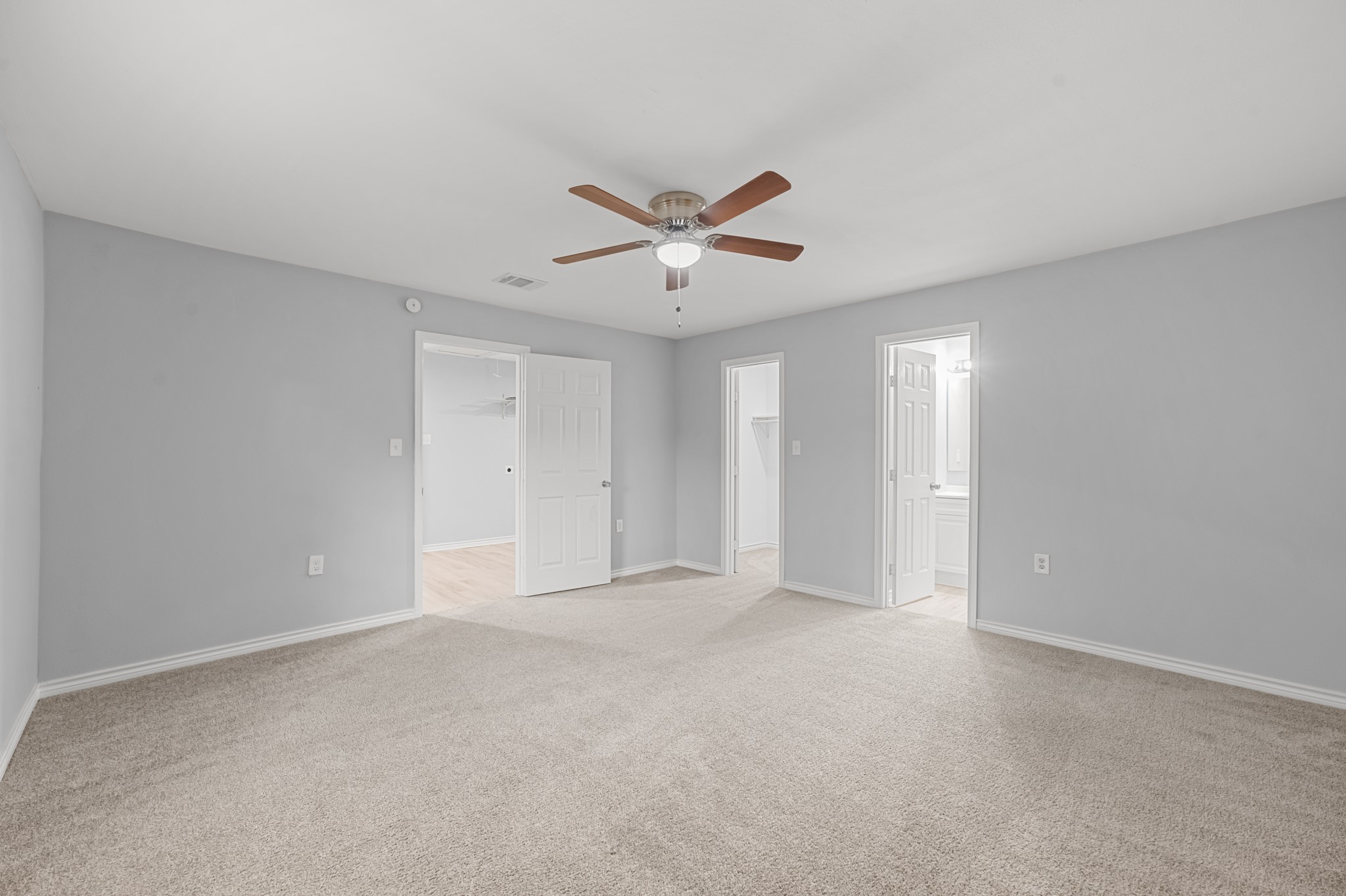 The primary suite features a spacious layout with convenient access to a private bathroom and walk-in closet, offering comfort and everyday functionality.