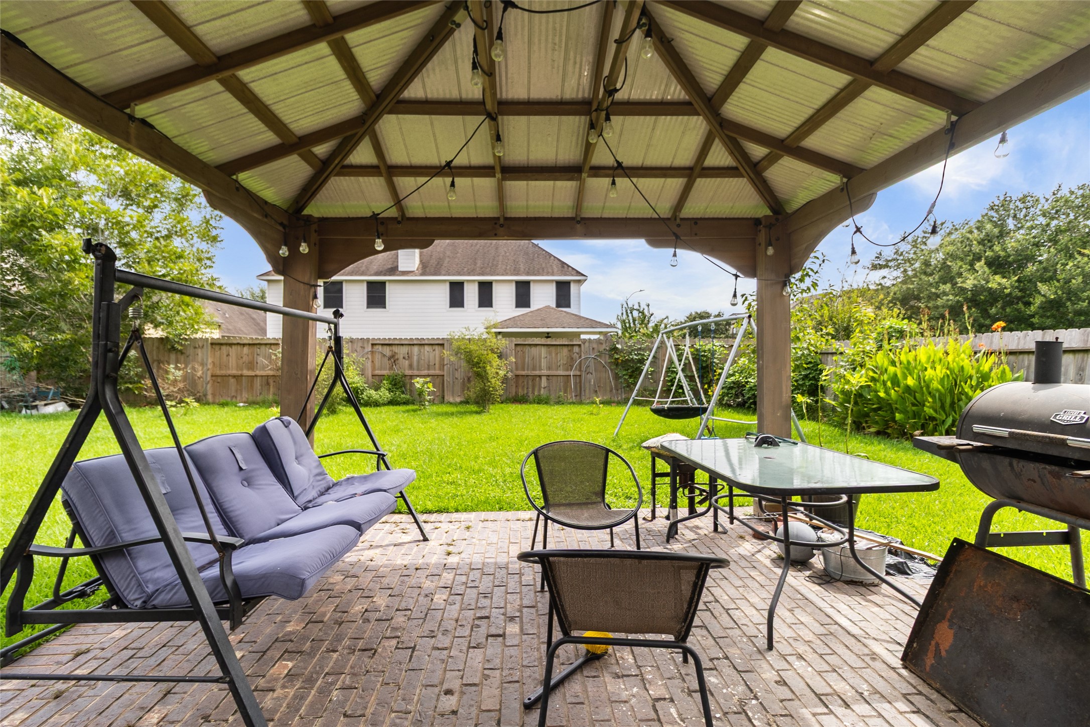 Weekends are made for relaxing under your covered backyard pavilion, where outdoor dining, grilling, and quiet evenings come together in your spacious fenced yard.