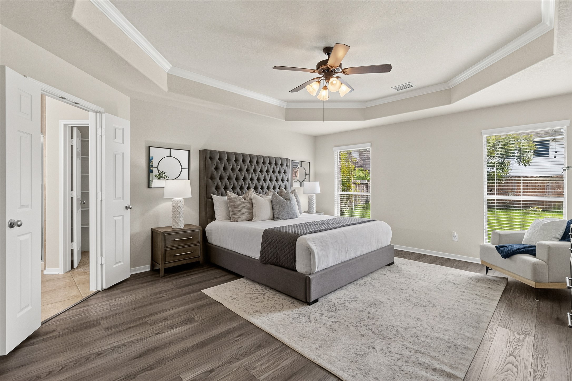 Your spacious primary suite offers a peaceful retreat with a tray ceiling, generous layout, and plenty of room to relax at the end of the day.