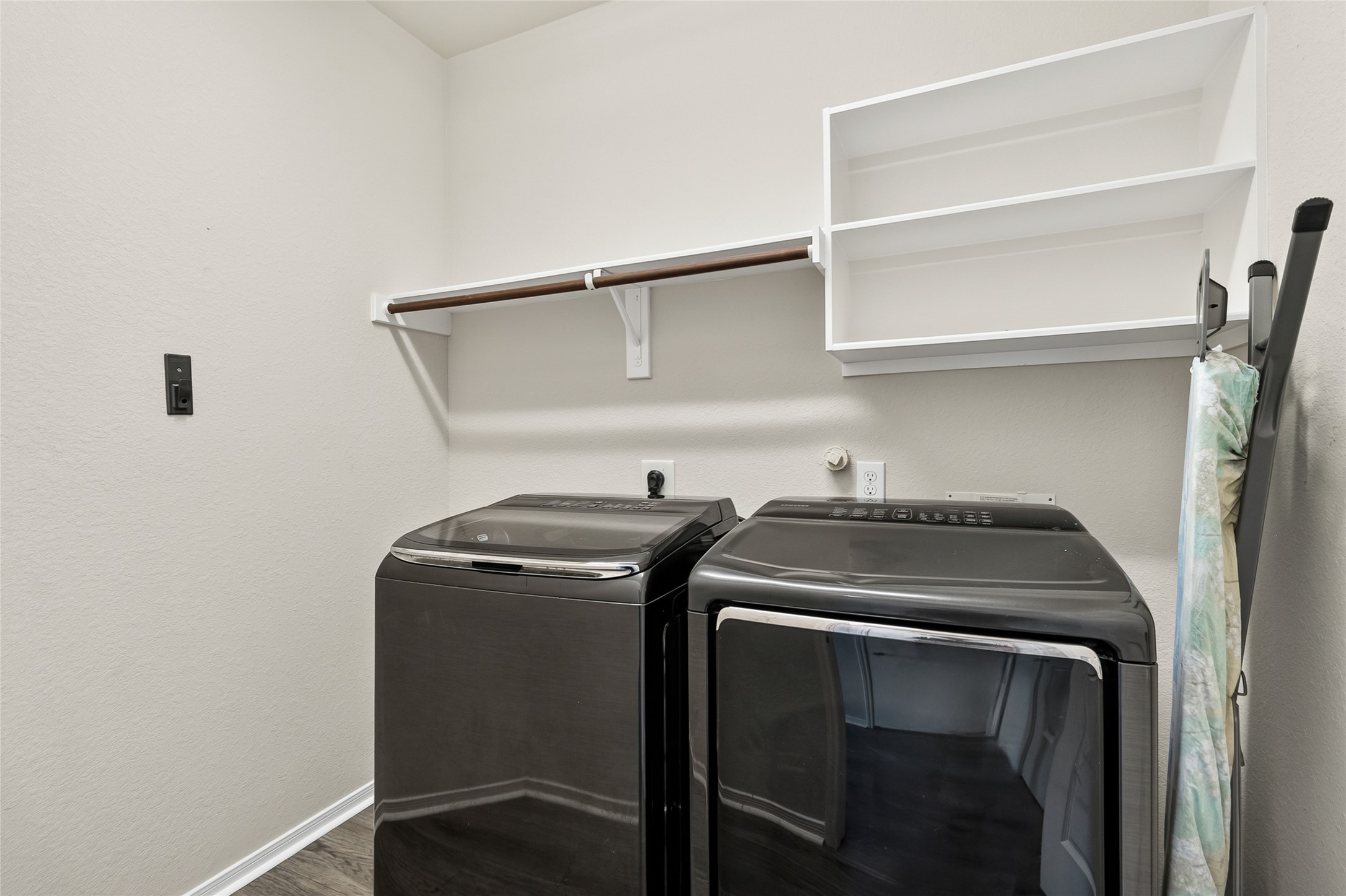 Laundry day becomes more convenient with a dedicated utility room offering extra shelving and space to keep household essentials neatly organized.
