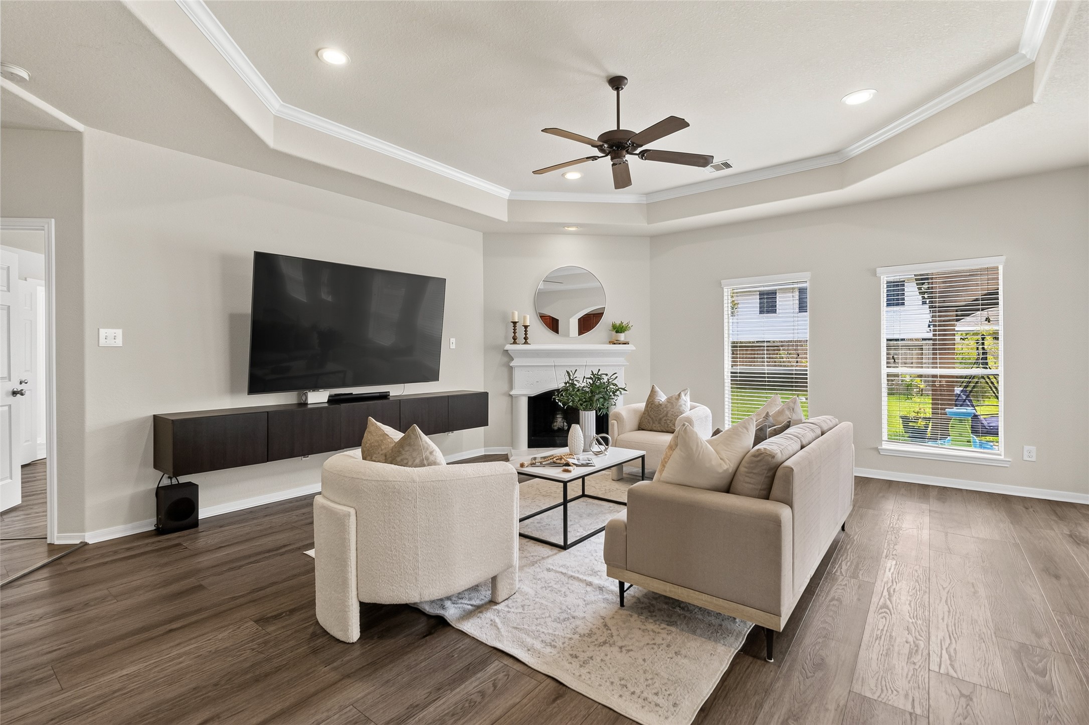 Relax by the fireplace or gather for movie nights in the spacious living room, where large windows fill the space with natural light.
