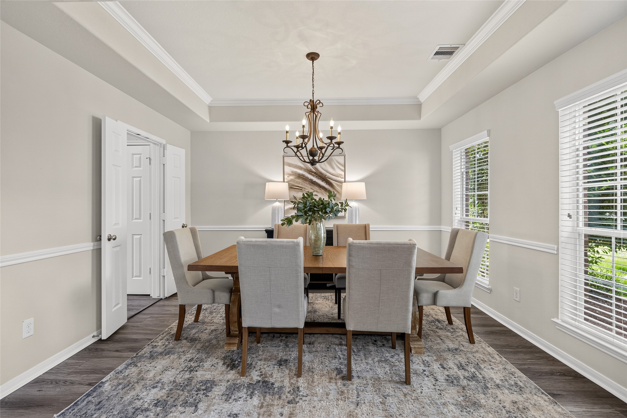 Your formal dining room is ready for holiday gatherings and dinner parties, complete with a tray ceiling, chandelier, and plenty of space for family and friends.