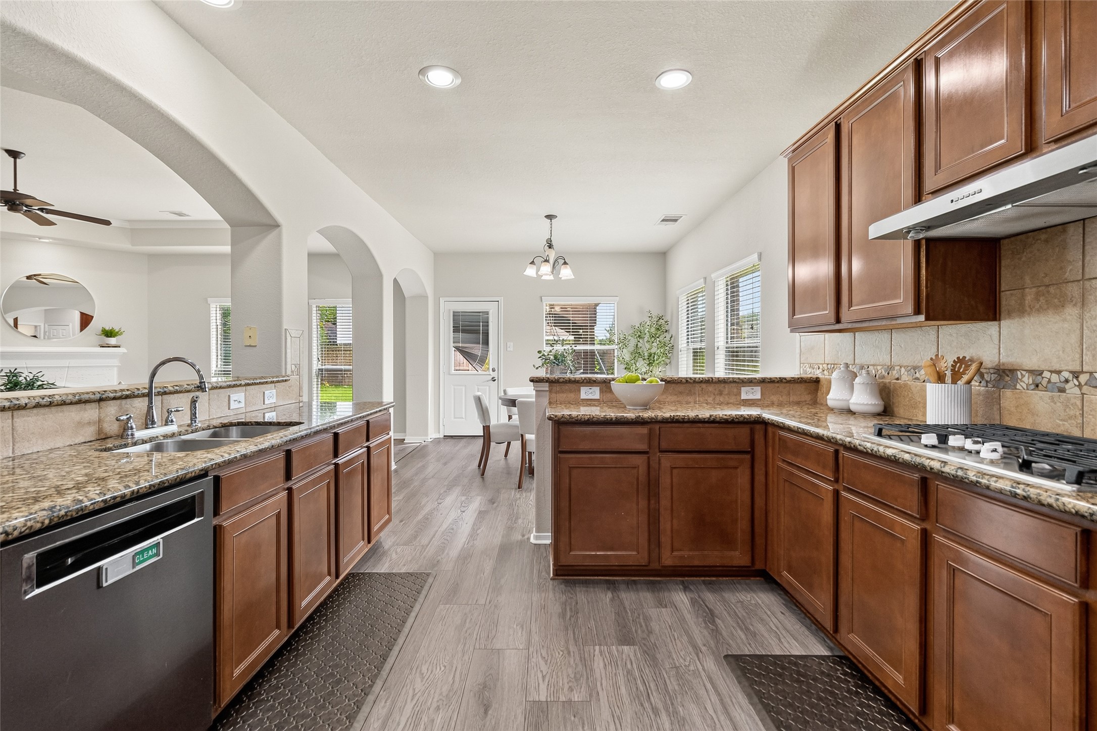 Cooking becomes a pleasure with expansive granite counters, a spacious island, ample storage, and an open design that keeps you connected to family and guests.