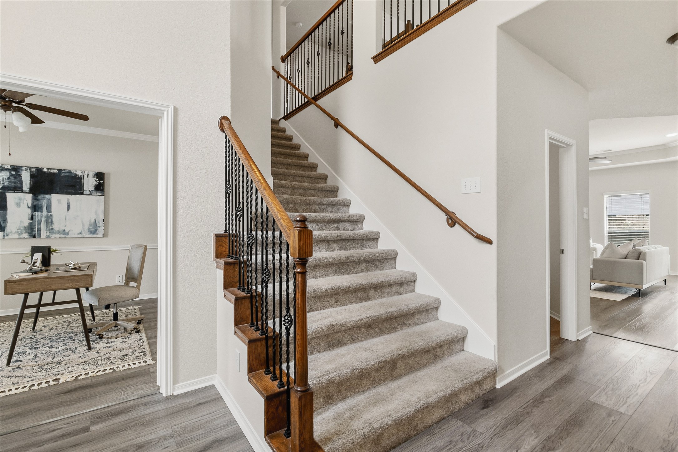 Your sweeping staircase and open foyer make moving between levels feel effortless while adding timeless character to the heart of your home.
