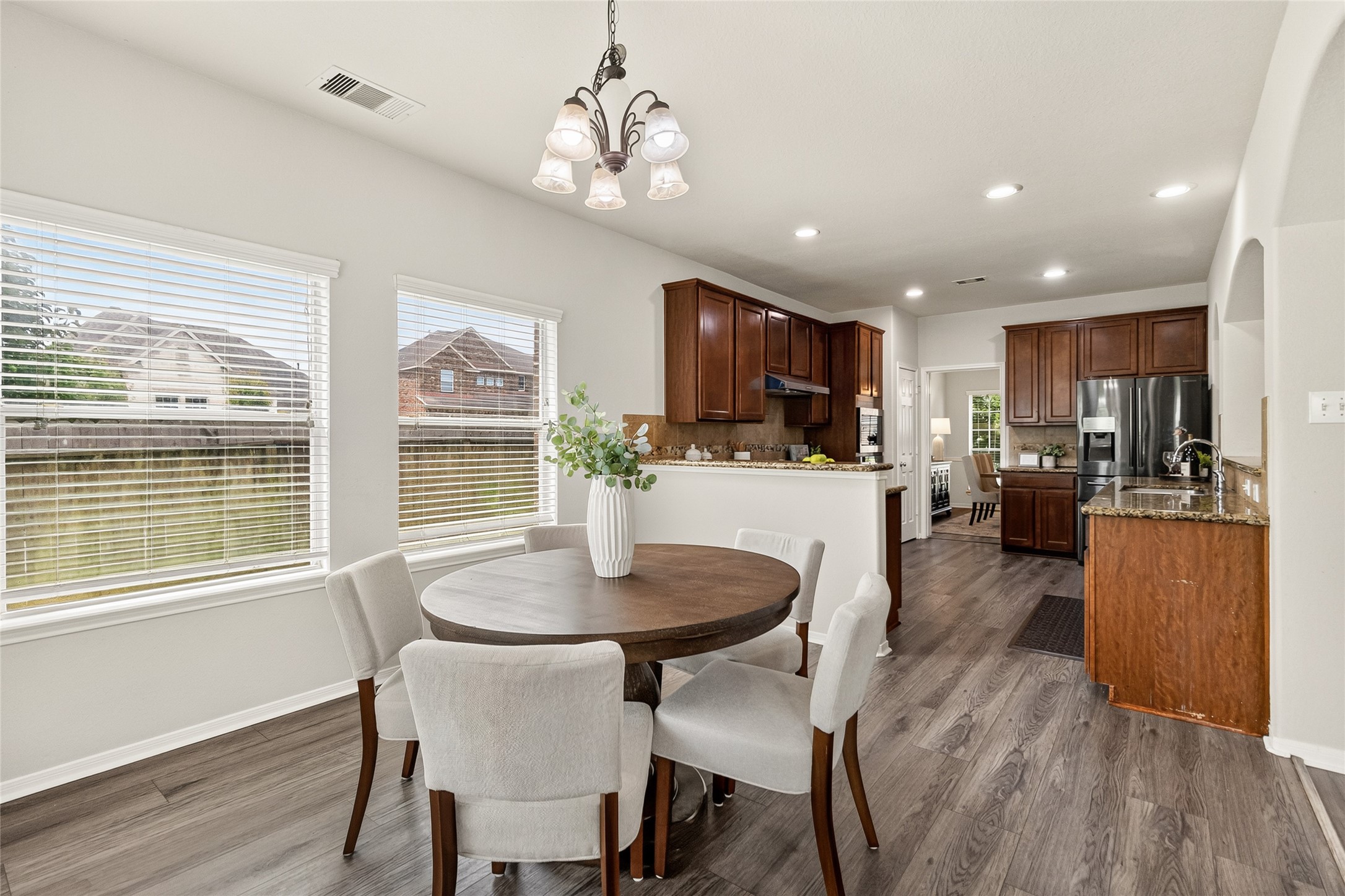 Casual meals and morning coffee become part of your daily routine in the sunny breakfast area overlooking the backyard.