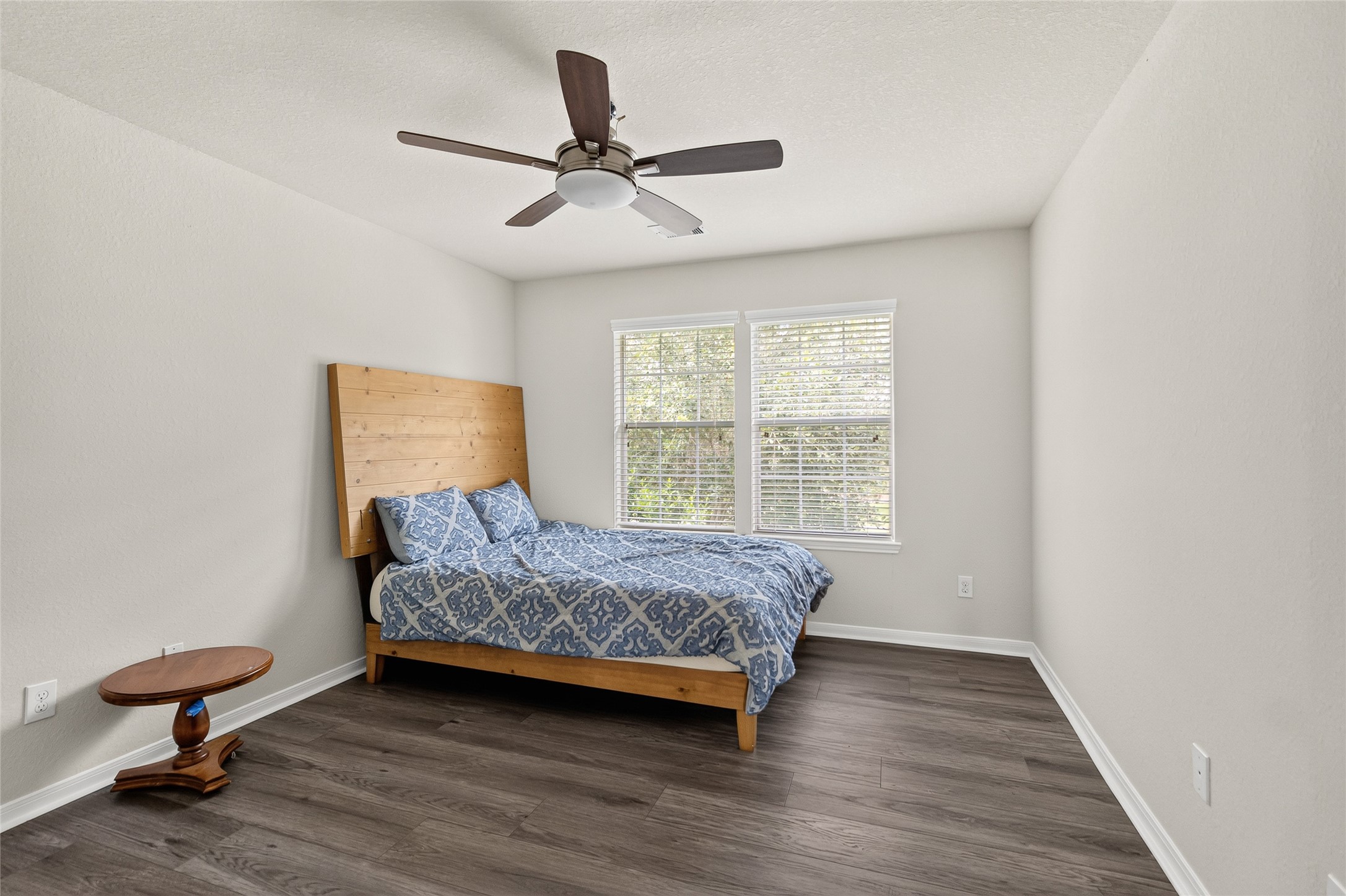 Another inviting bedroom offers a bright, comfortable setting that's perfect for family, guests, or a private home office.