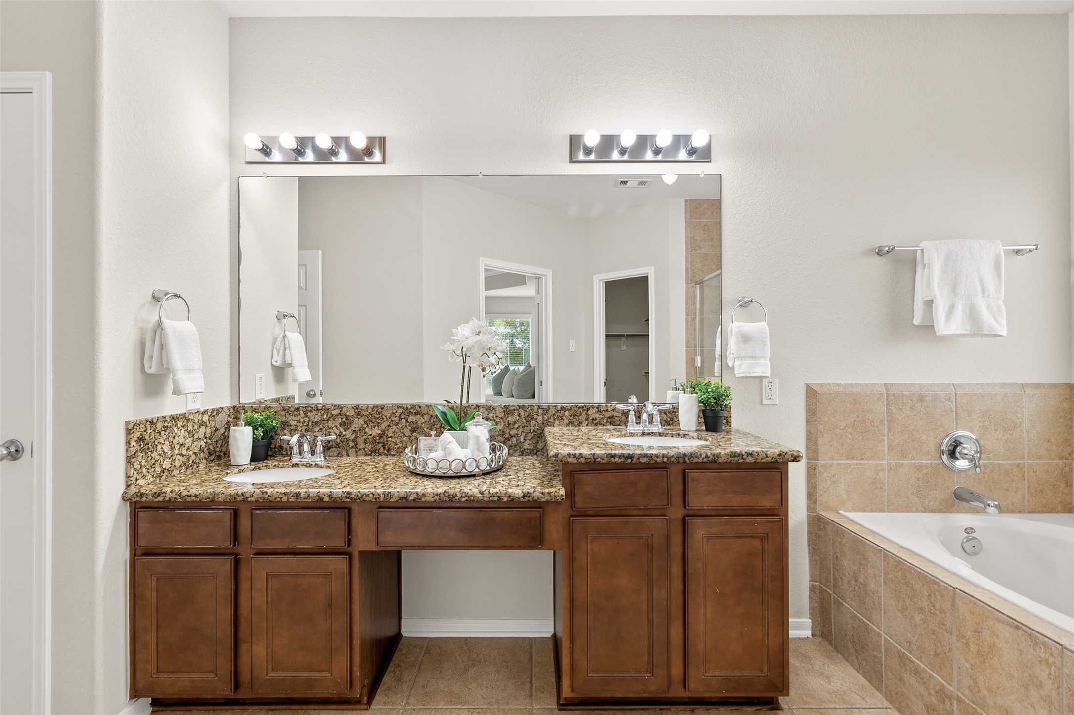 Getting ready is effortless with a spacious dual-sink vanity, granite countertops, and plenty of room for your daily routine.