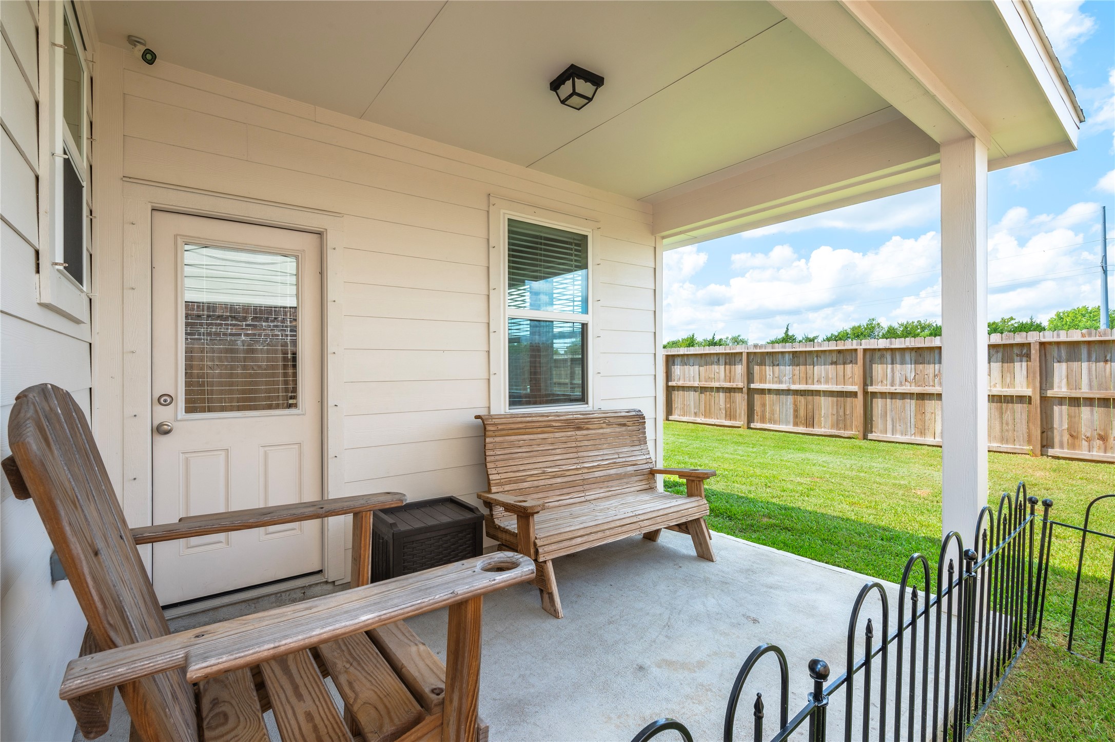 Charming covered patio perfect for relaxing and enjoying the view of the spacious fenced backyard. New fence was installed last year.