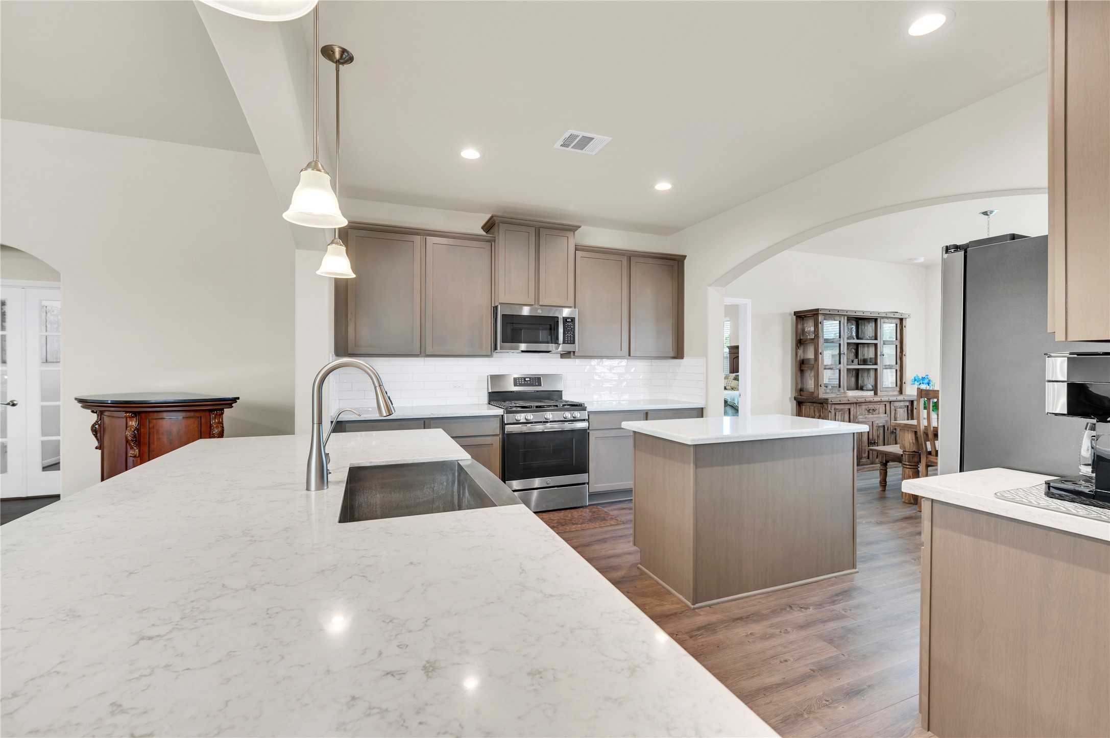 This modern kitchen also features a second island for food prep and meal set up.  as well as an abundance of cabinets for plenty of storage.
