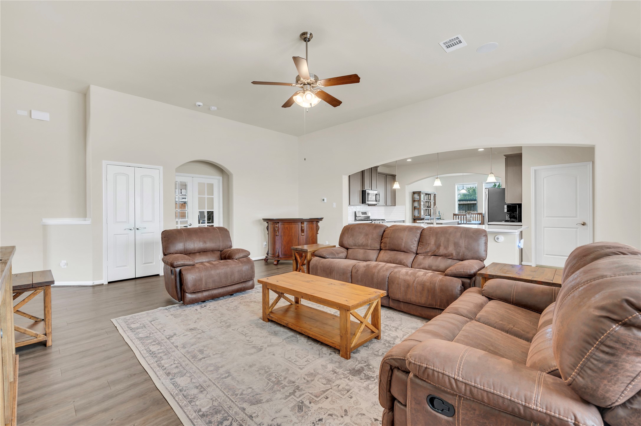 The living area features luxury vinyl floors that are carried thru out the home. Open access to a modern kitchen, perfect for entertaining and relaxation. The living area features luxury vinyl floors that are carried thru out the home. Open access to a modern kitchen, perfect for entertaining and relaxation.