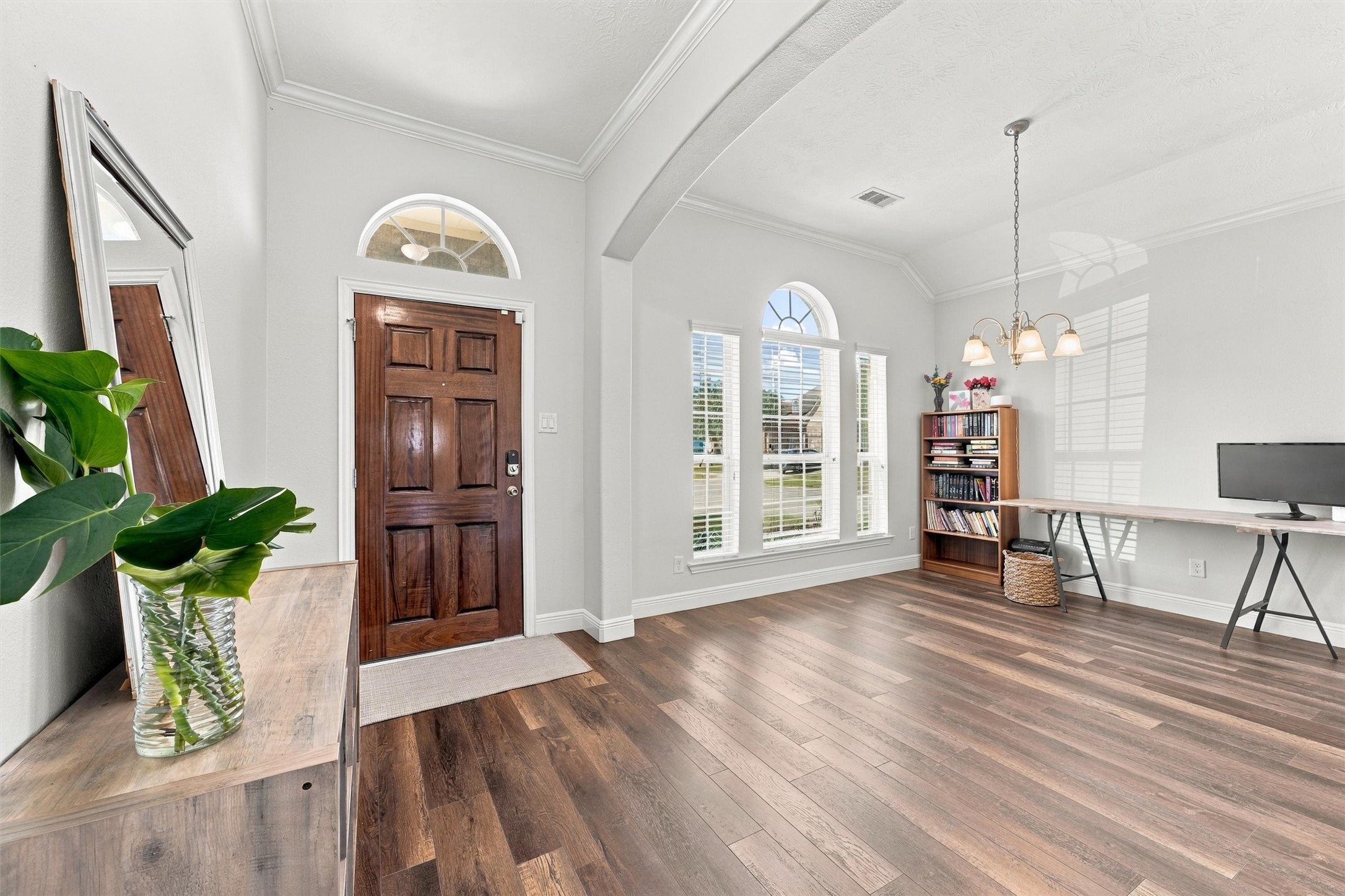 Inviting entry welcomes you into a bright interior with fresh neutral paint and new wood flooring.