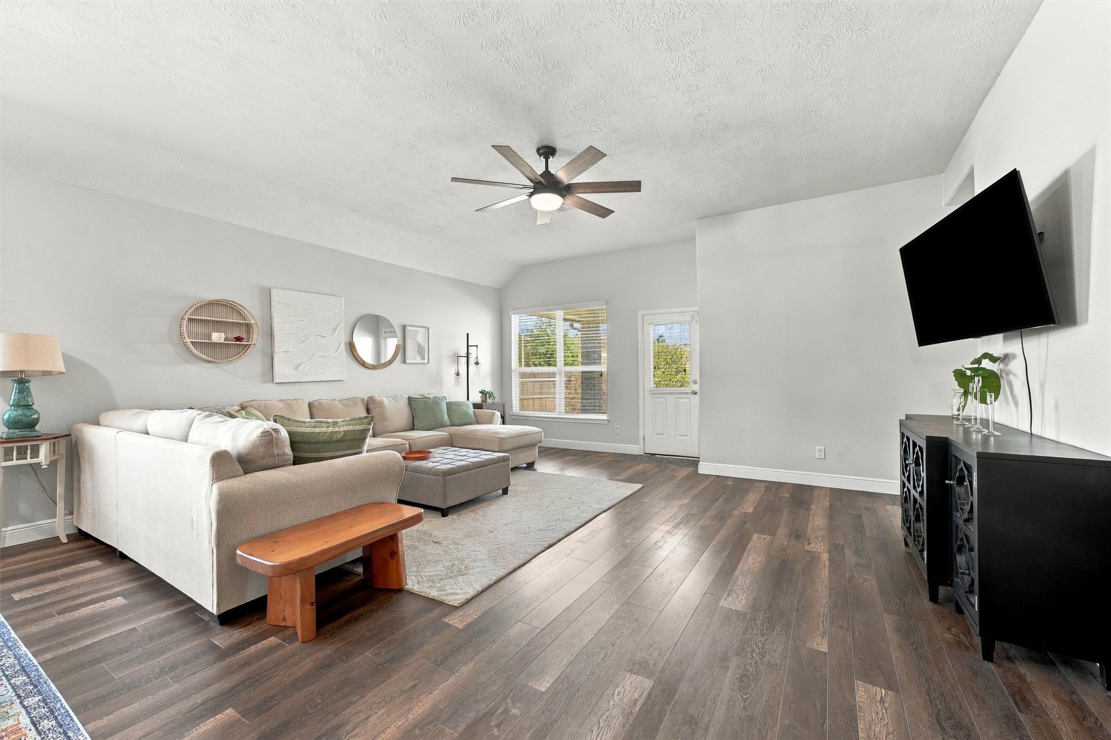 Spacious living room features beautiful new wood flooring and an inviting, open layout.