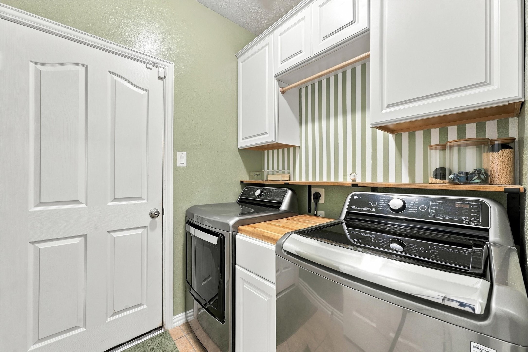 charming laundry and mud room off of the three-car garage.
