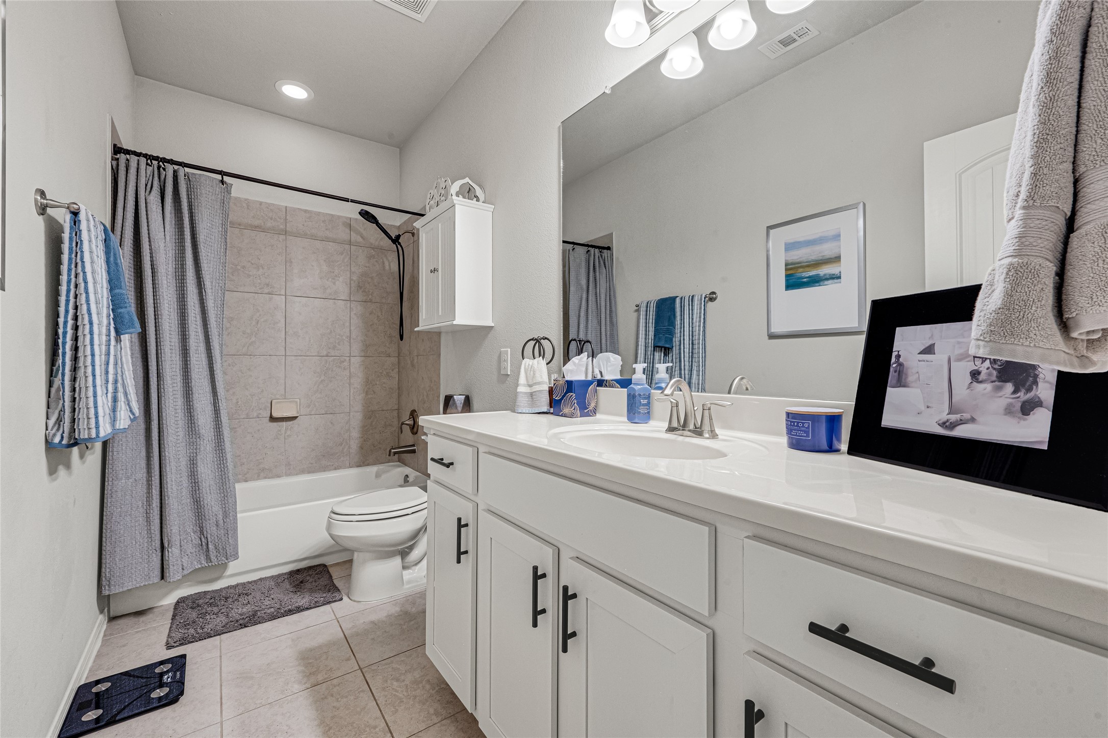 Secondary bathroom with dual sinks and ample counter space.
