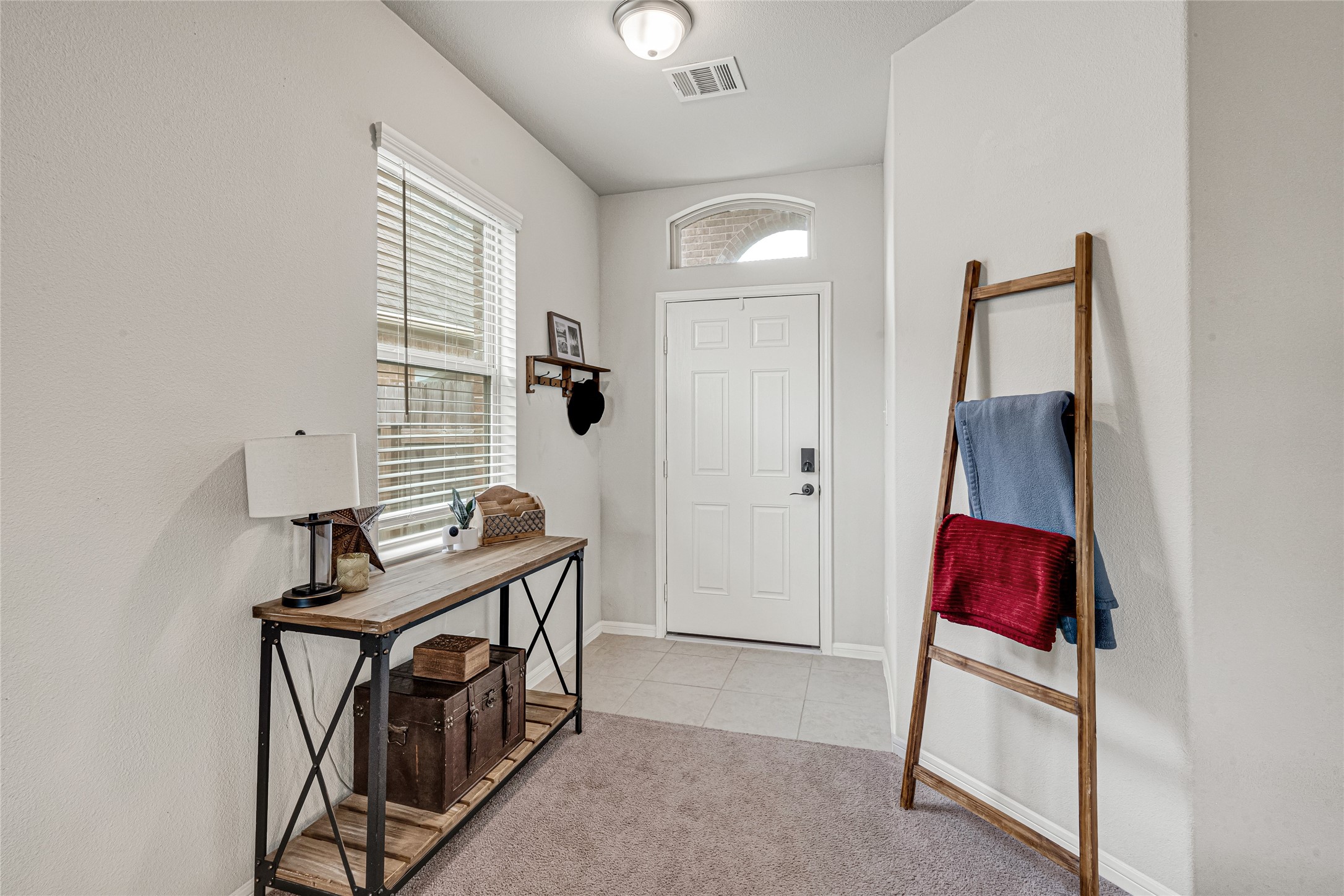 Bright and welcoming foyer with high ceilings.