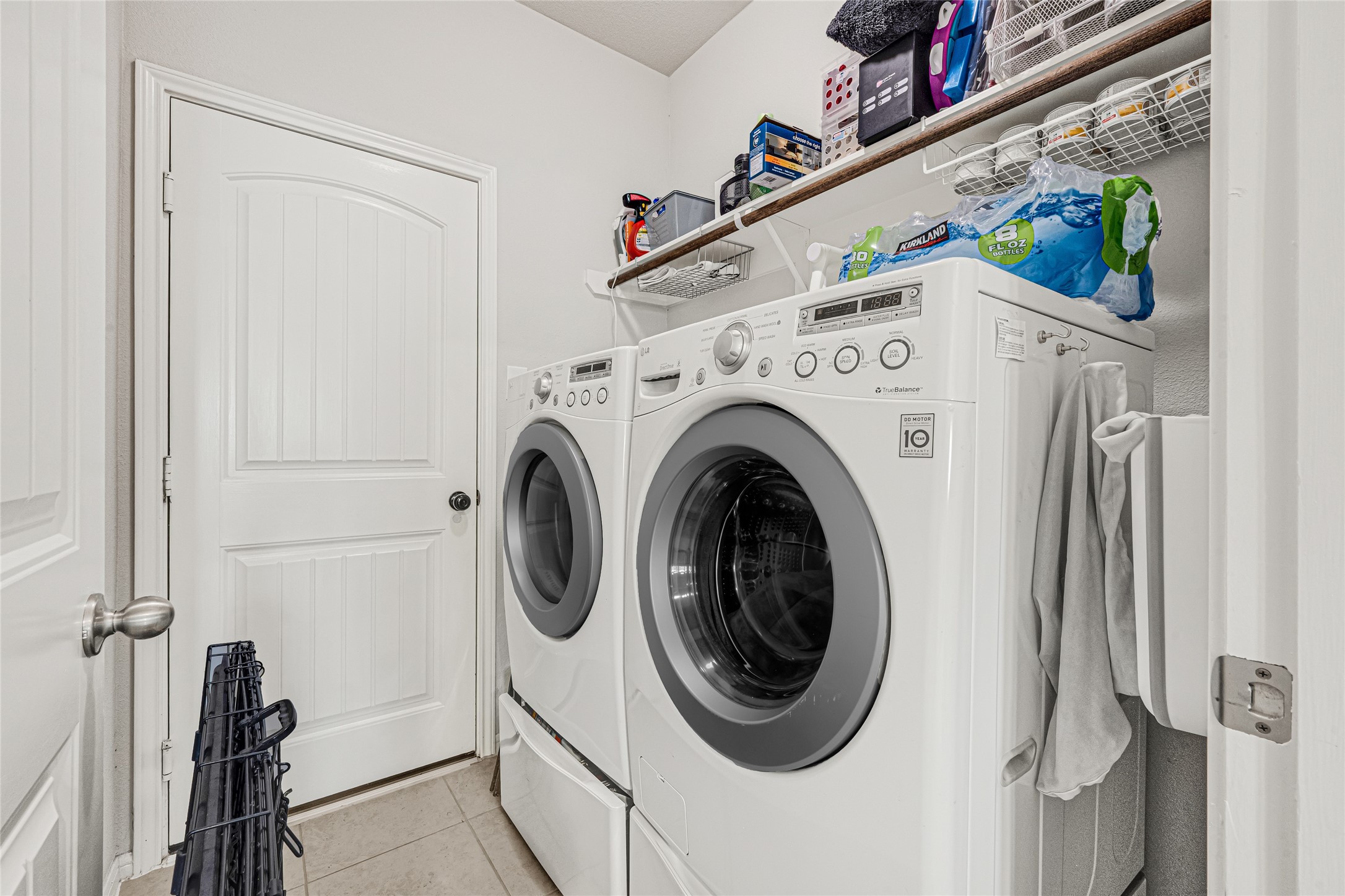 Convenient indoor utility room with additional shelving for storage.