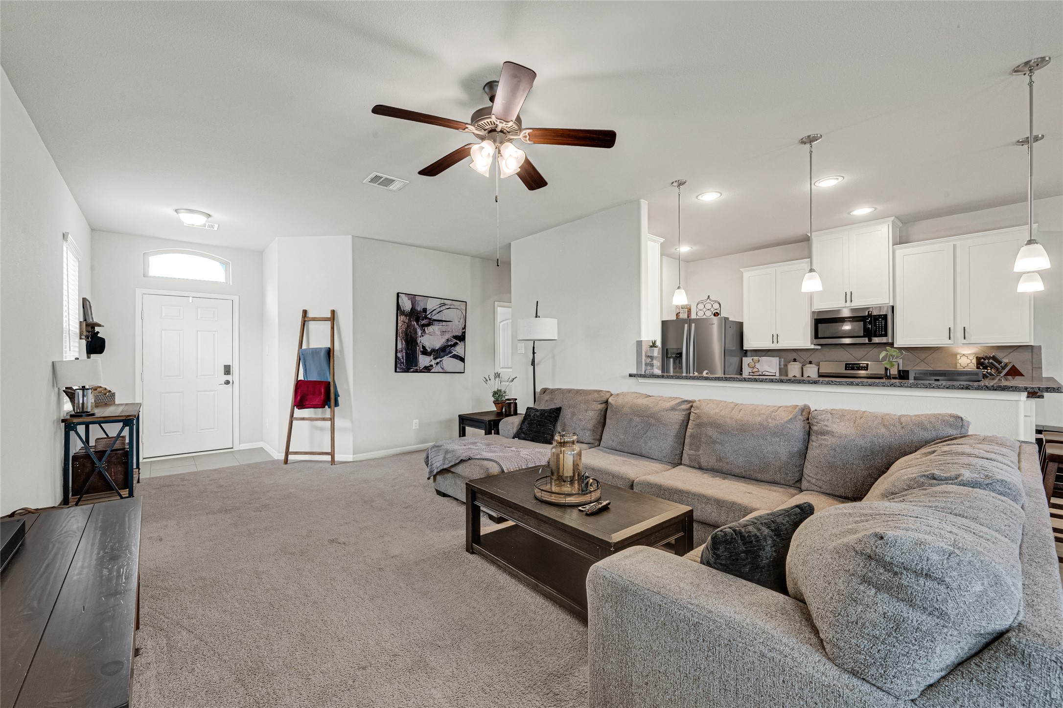Open-concept living area with abundant natural light and seamless flow to the kitchen. Open-concept living area with abundant natural light and seamless flow to the kitchen.