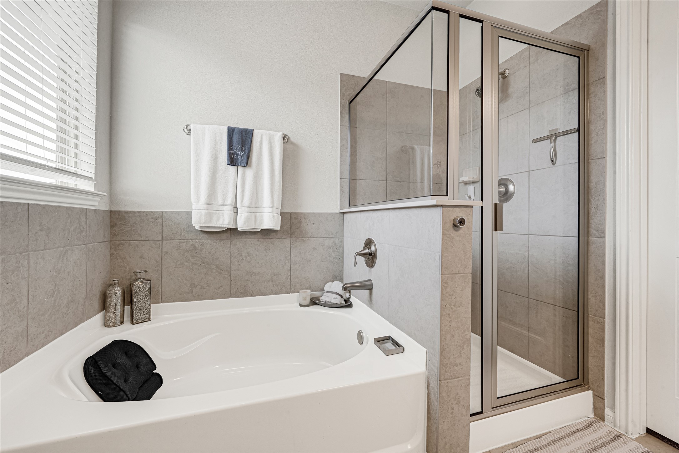 Primary bathroom featuring soaking tub and separate shower.