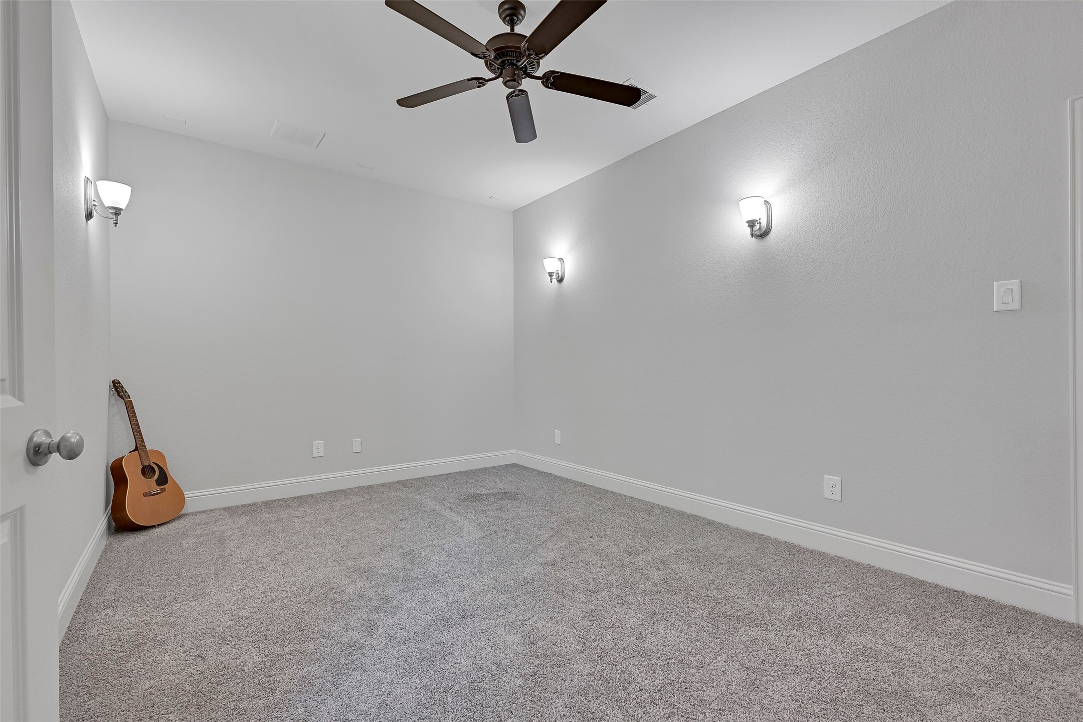 Just off the gameroom, the dedicated media room is ready for movie nights, gaming, or binge-watching your favorite shows. Sconce lighting, plush carpeting, and a tucked-away location create a theater-like atmosphere, while the generous dimensions easily accommodate multiple rows of seating.