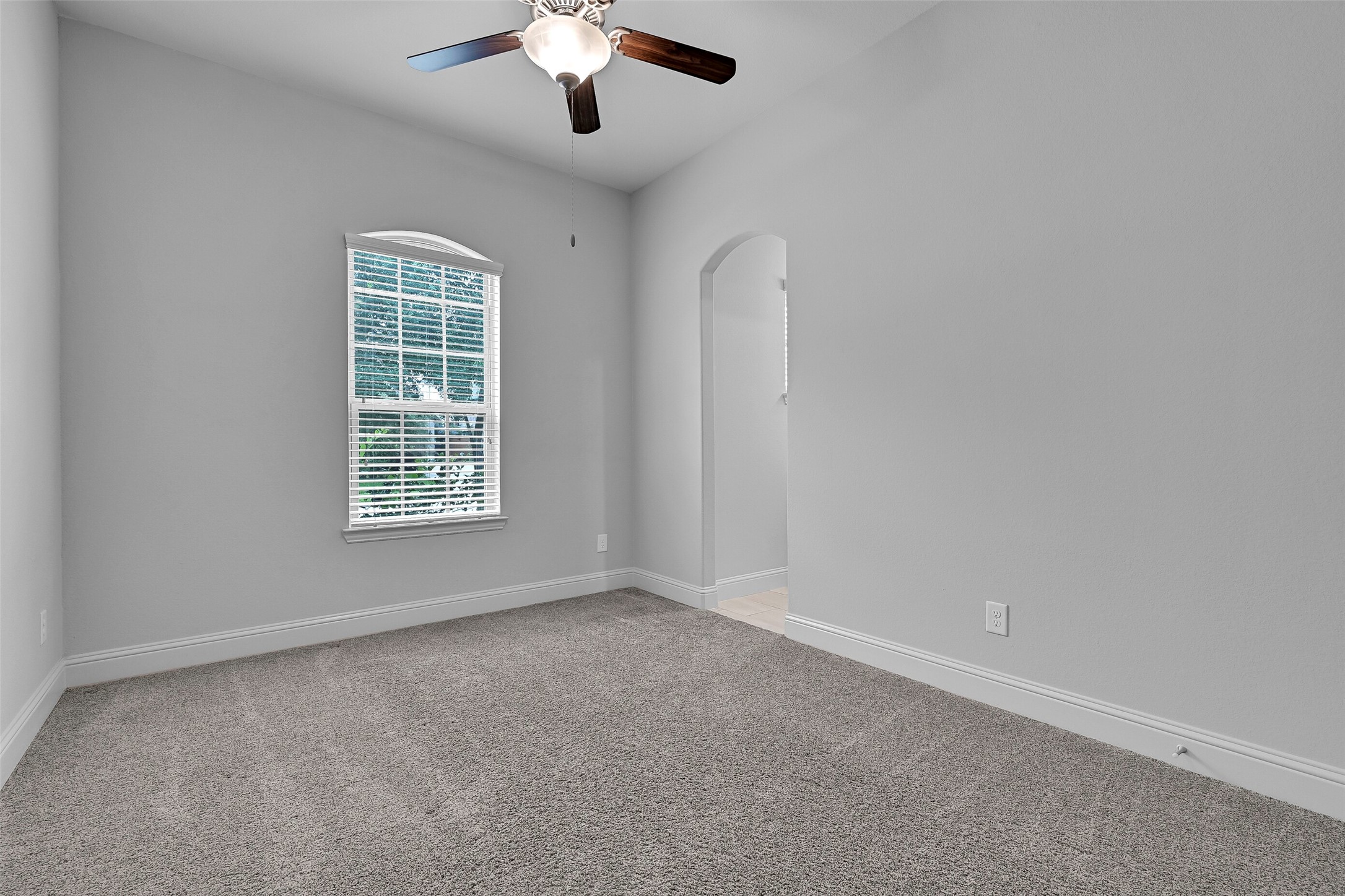 Located adjacent to the shared bath, this generously sized secondary bedroom offers plush carpeting, a ceiling fan, abundant natural light, and direct access to the Jack & Jill bathroom. The versatile space works equally well as a bedroom, nursery, or hobby room.
