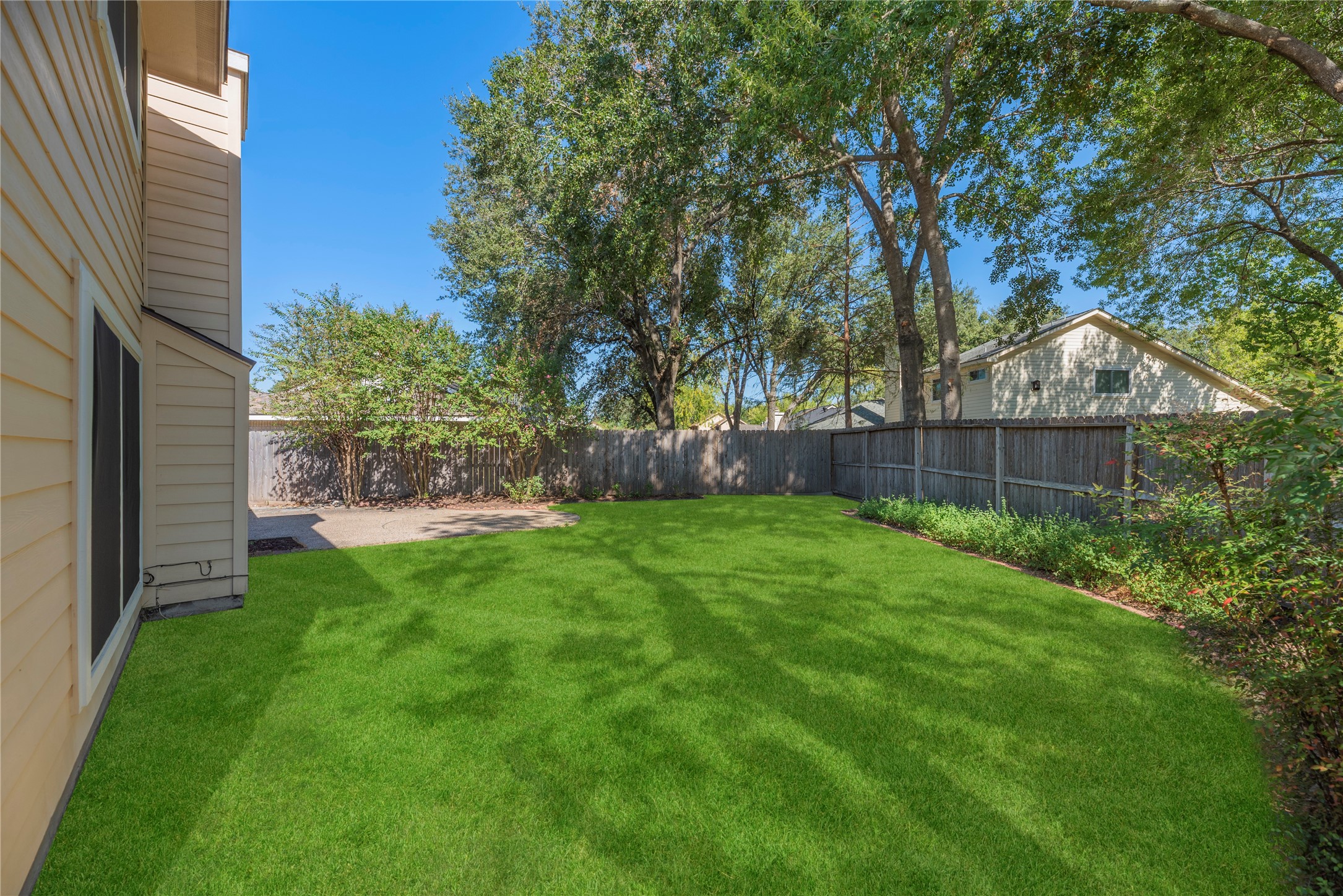 Step outside to a private backyard with a patio area. Grass has been digitally enhanced to show potential.