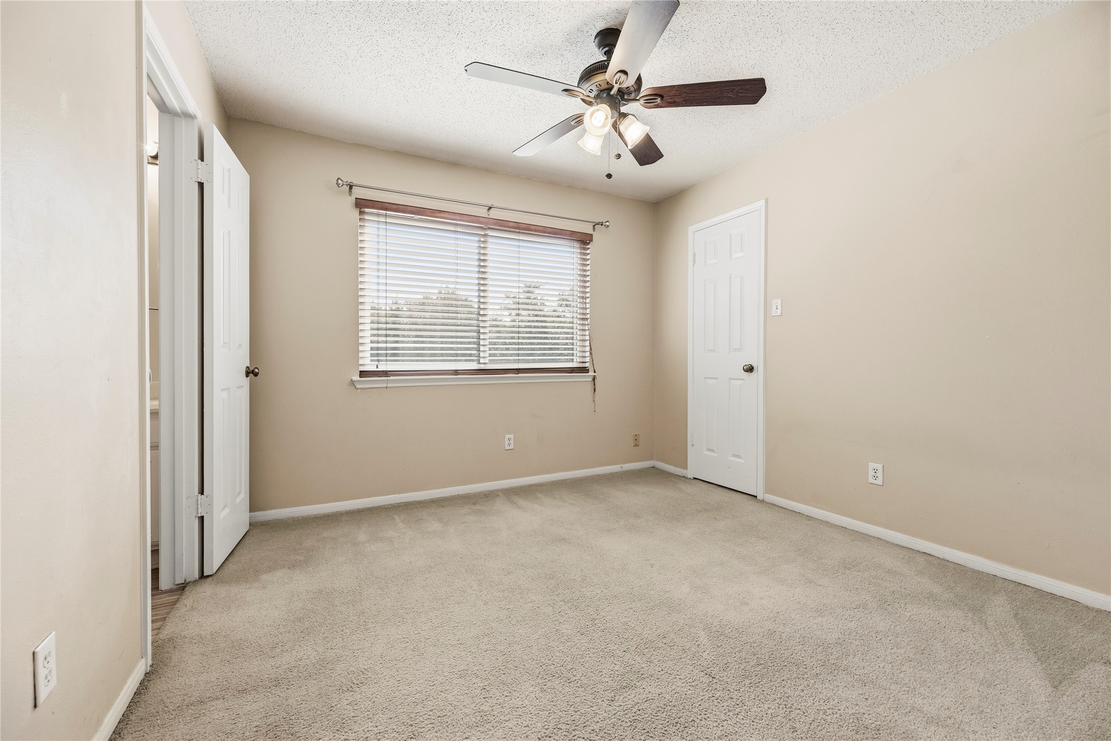 Both upstairs secondary bedrooms offer carpeted flooring, ceiling fans and ample closet space.
