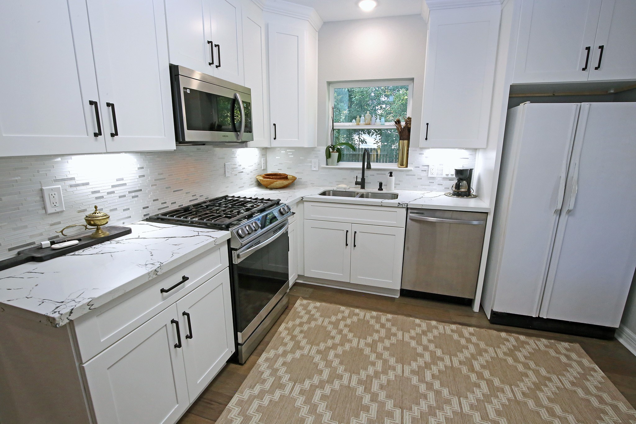 Come on in the Kitchen with Quartz countertops, gas stove, dishwasher and microwave.