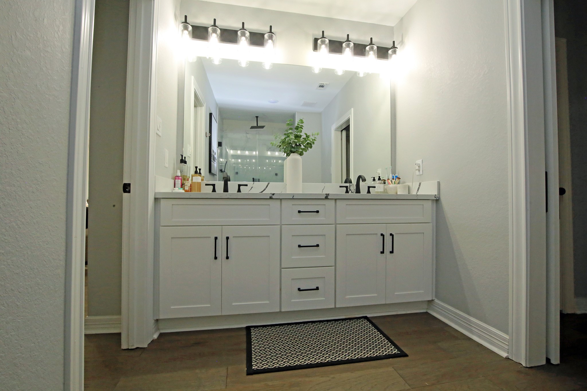 Plenty of lighting in the mirror with double sinks and storage!