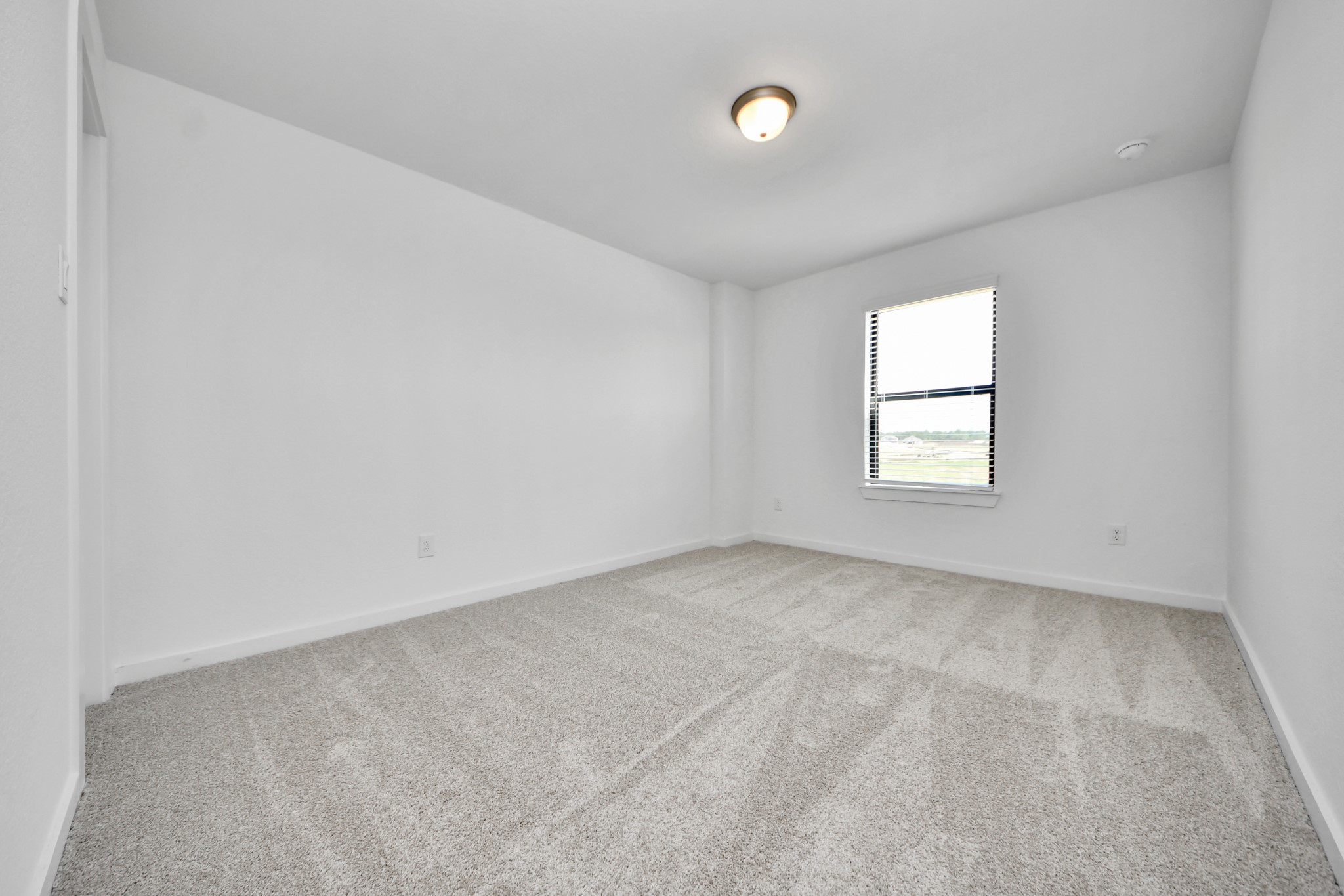 Generously sized secondary bedrooms featuring spacious closets, soft and inviting carpeting underfoot, large windows allowing plenty of natural light, and the added touch of privacy blinds for your personal retreat.