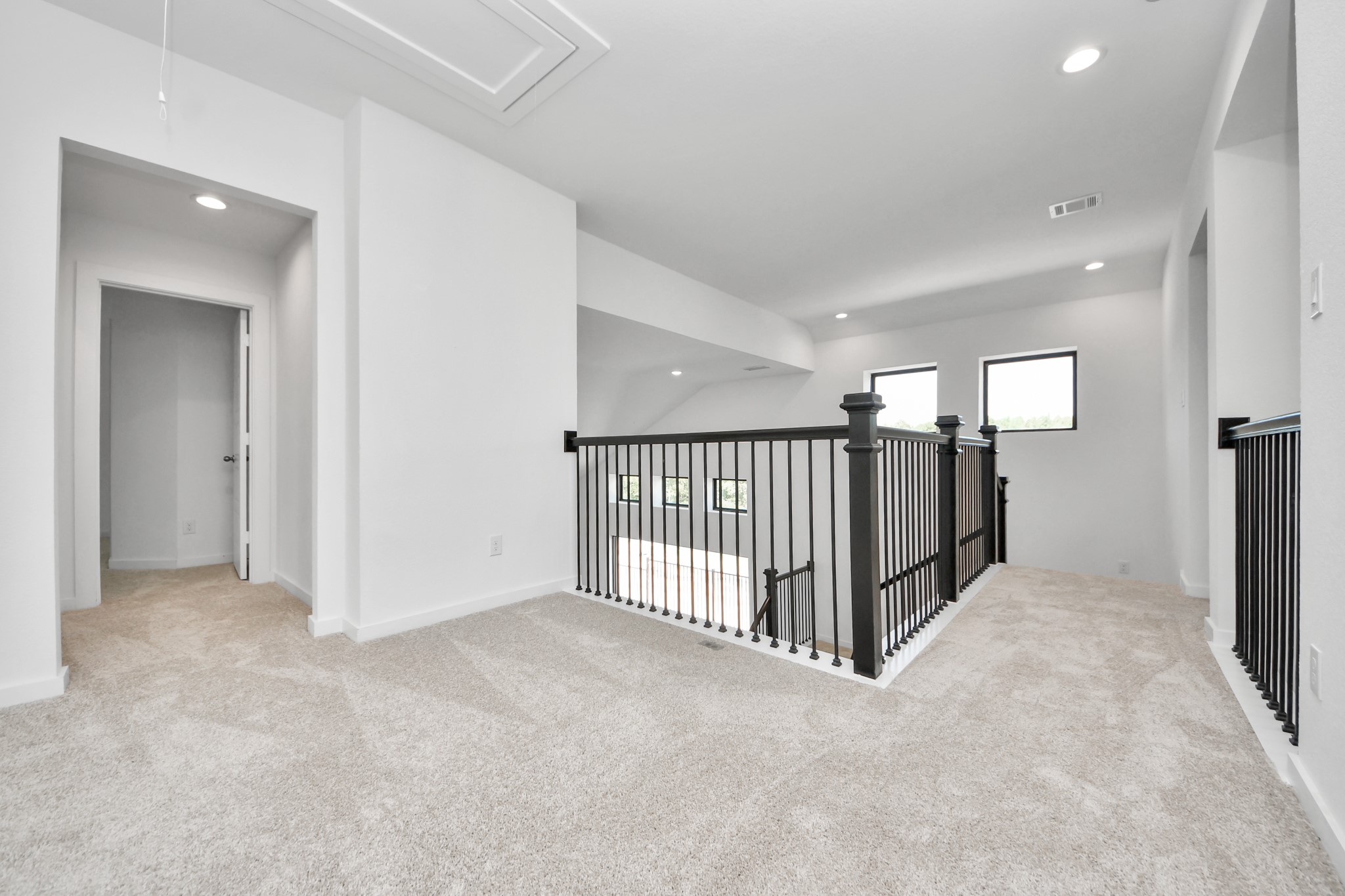 Ascend to relaxation in this fantastic game room! Ideal for both casual gatherings and adult gaming, it boasts plush carpet, lofty ceilings, custom paint, and ample windows for abundant natural light.