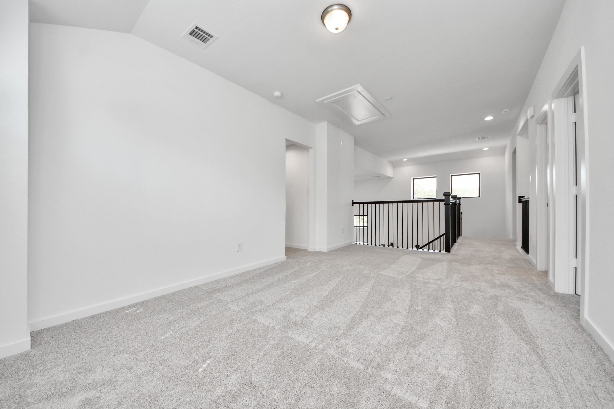 Come upstairs and enjoy a day of leisure in this fabulous game room! This is the perfect hangout spot or adult game room! Features plush carpet, high ceilings, custom paint and windows for plenty of natural light.