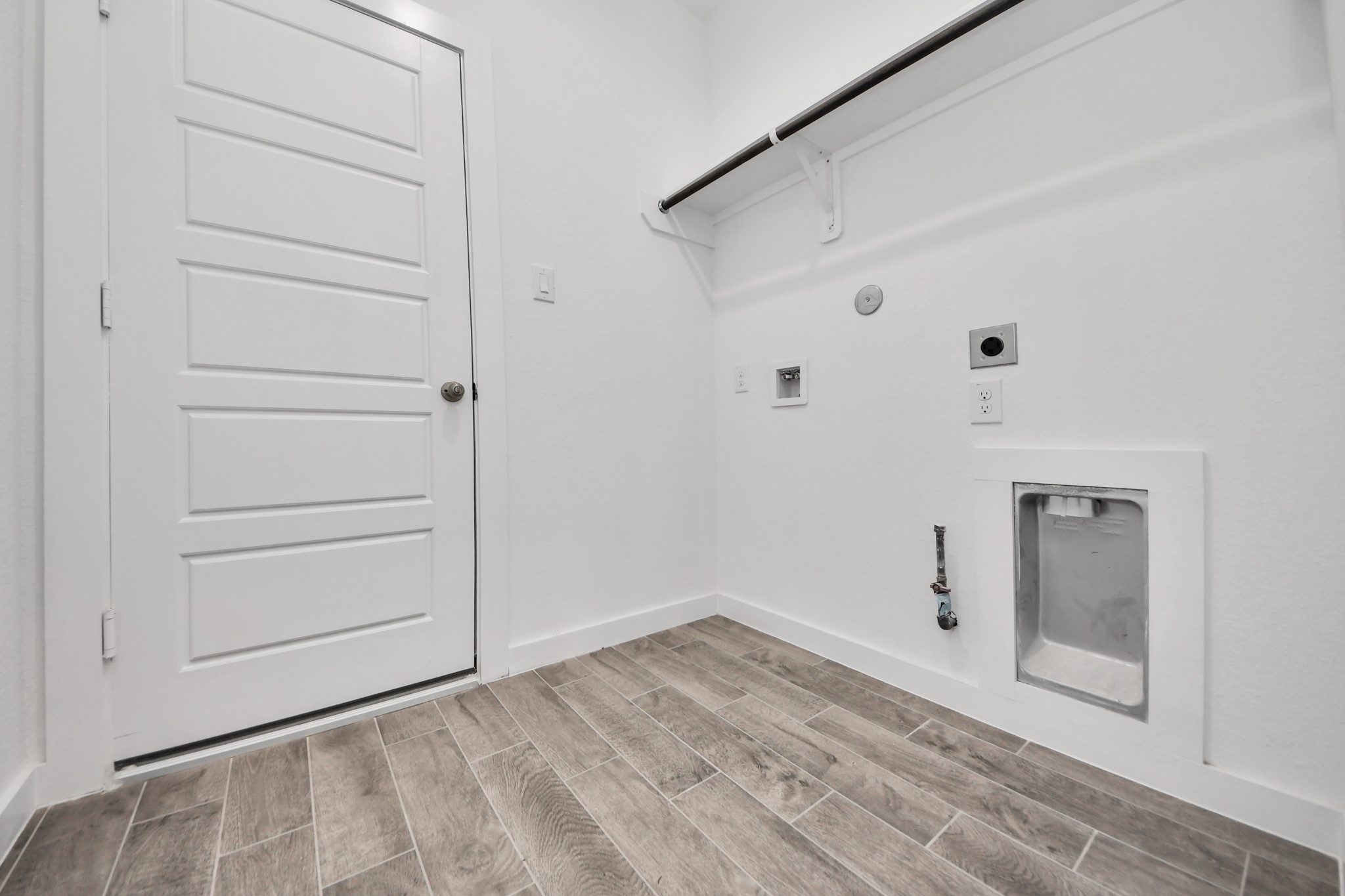 A perfect blend of functionality and comfort. Capture the essence of easy living with a first-floor laundry room, thoughtfully equipped with shelving for effortless organization. Both electric and gas connections available.