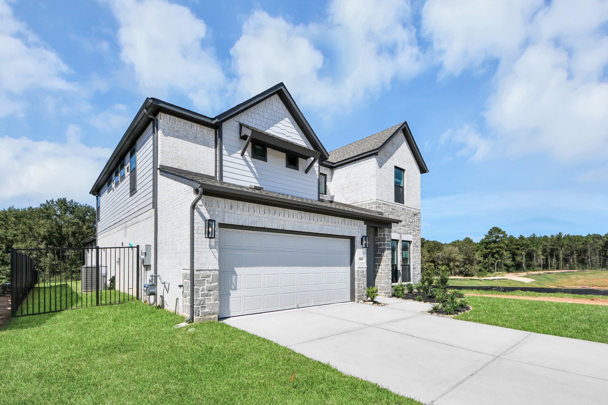 Behold a lush landscape, impeccably maintained yard, and a premium elevation adorned with captivating brick and stone features. Behold a lush landscape, impeccably maintained yard, and a premium elevation adorned with captivating brick and stone features.
