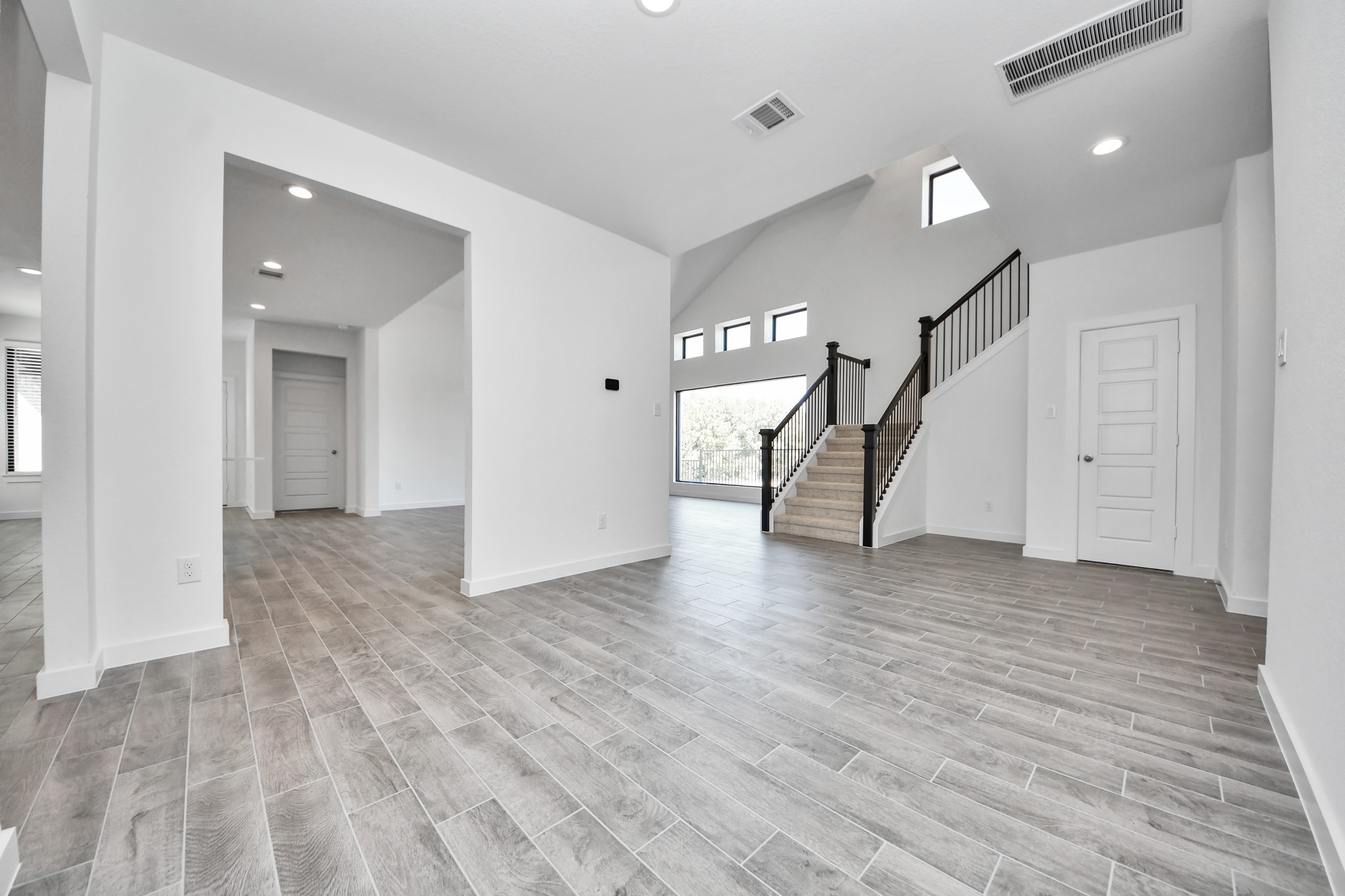 Create lasting memories with your family and friends at the dining table! This expansive dining room showcases sophisticated flooring, custom paint, and seamlessly connects to the family room and kitchen, providing an open and inviting atmosphere