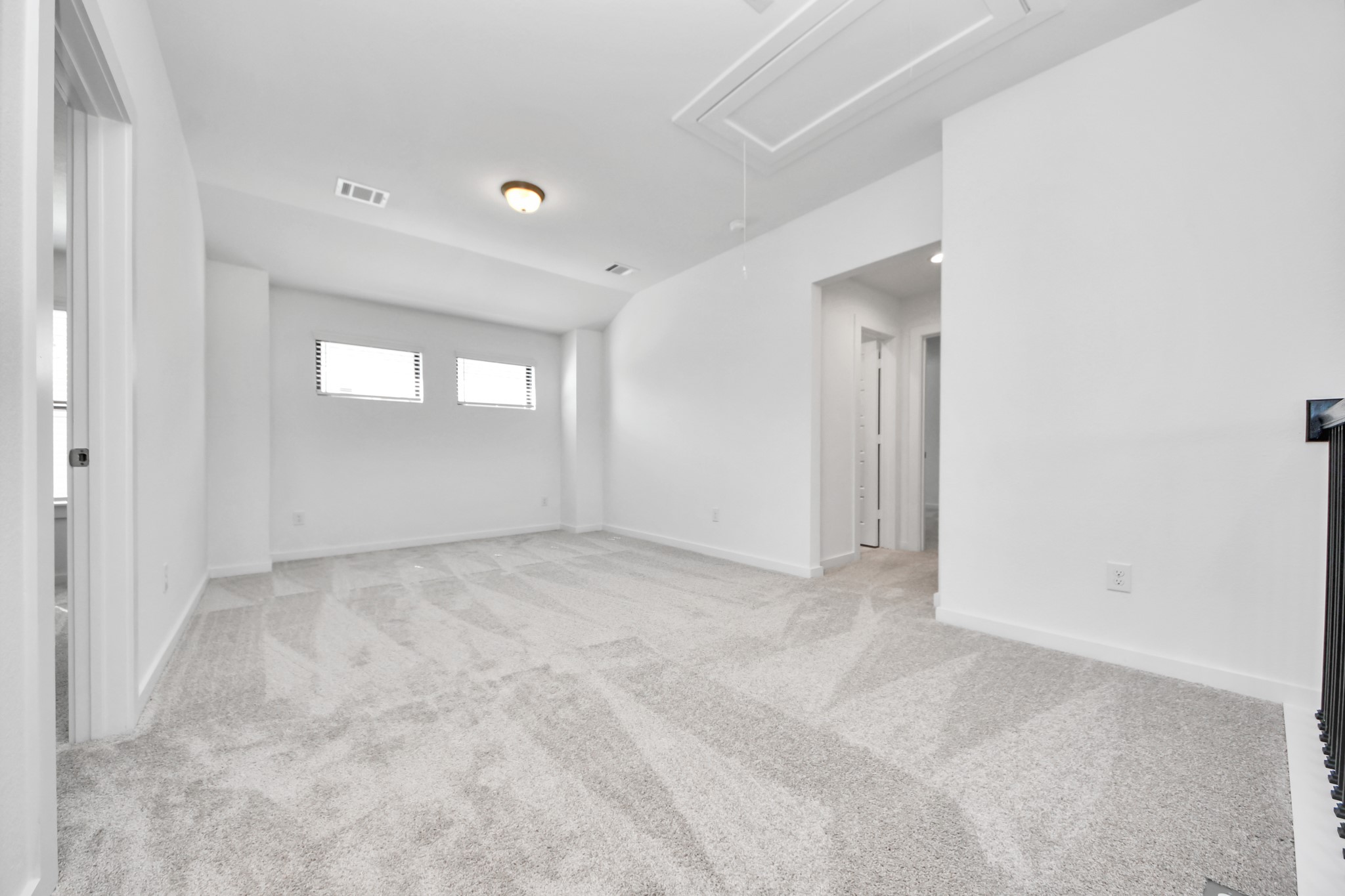 Ascend to relaxation in this fantastic game room! Ideal for both casual gatherings and adult gaming, it boasts plush carpet, lofty ceilings, custom paint, and ample windows for abundant natural light.