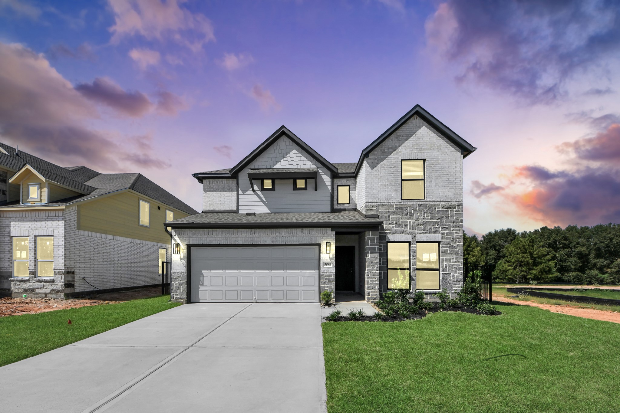 Meticulously maintained yard and lush landscape, paired with a premium elevation featuring captivating brick accents. Modern coach lights add a touch of contemporary elegance to the exterior.