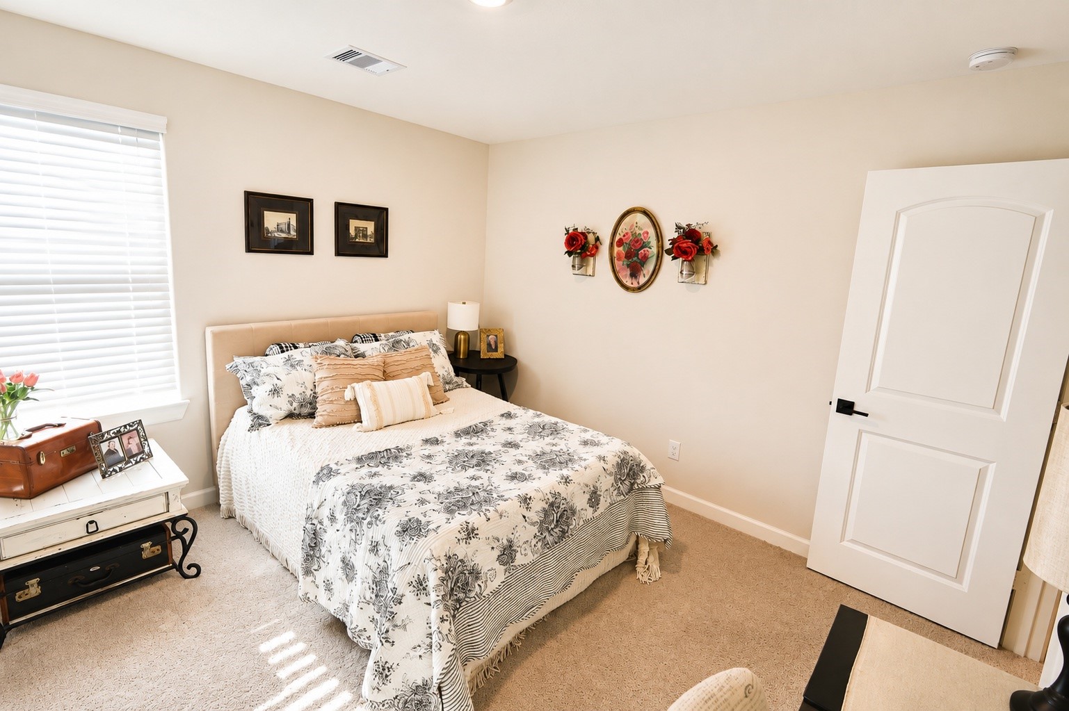 Large secondary bedroom with soft carpeting, abundant natural light.