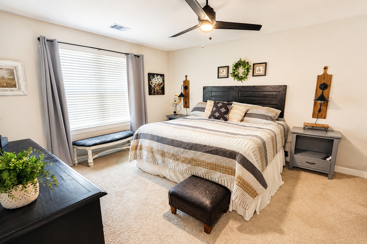 Primary bedroom with large king size bed with an abundance of natural lightening.