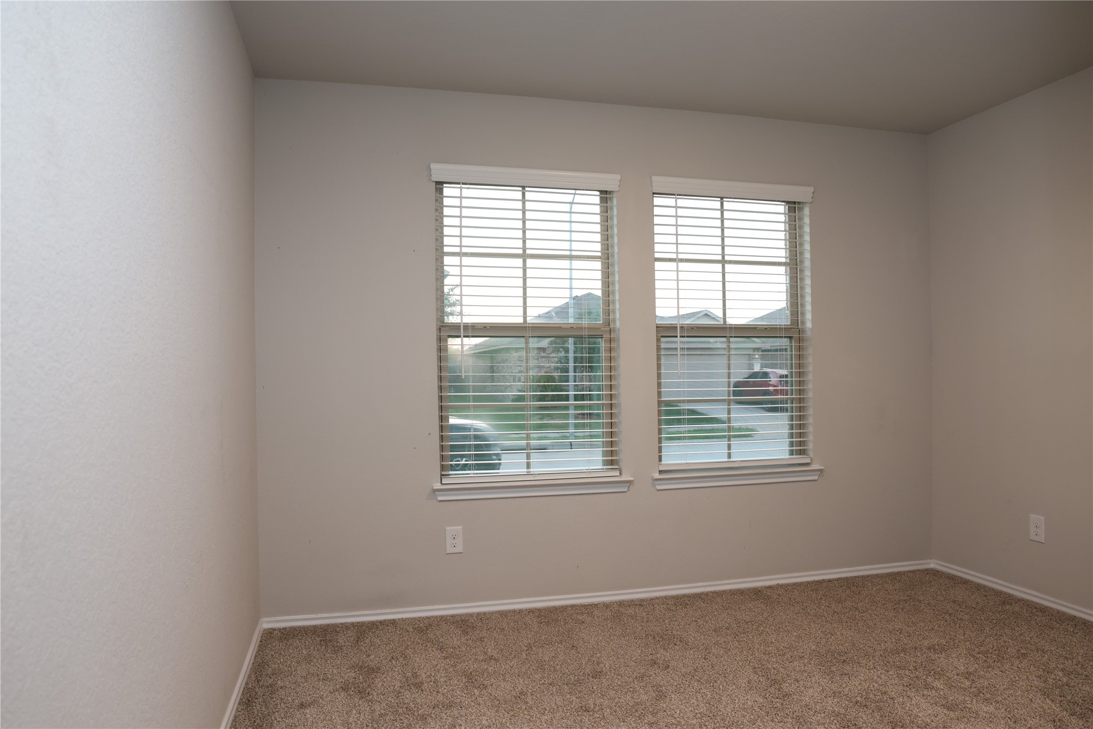 4th bedroom Bright and cozy room featuring dual windows with blinds