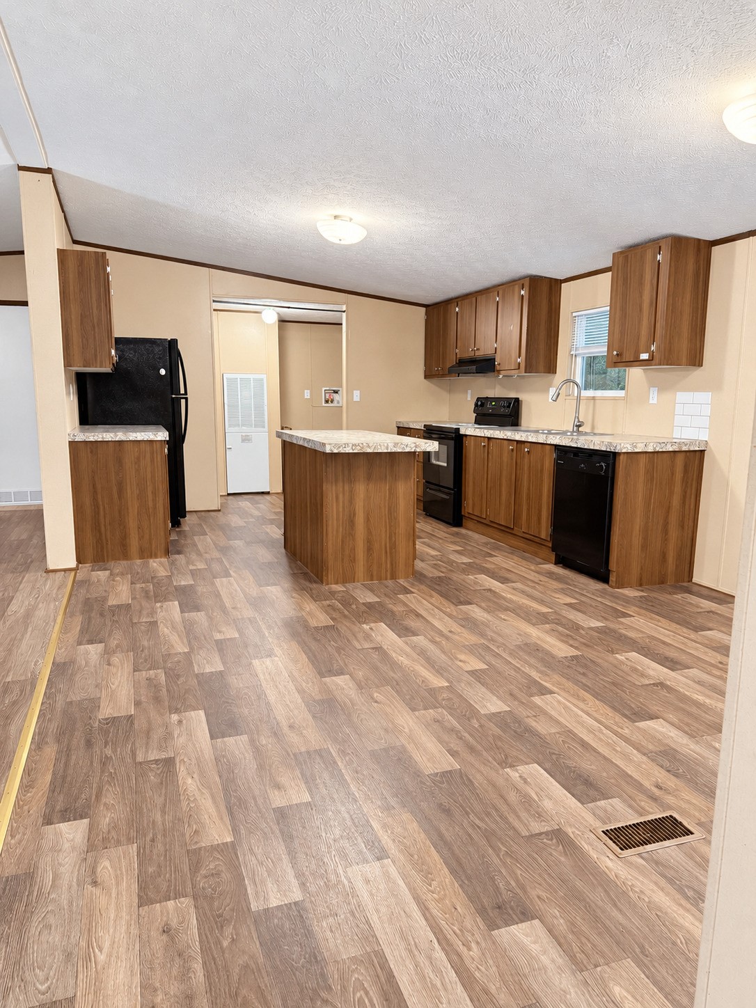 View of Kitchen and Utility Room from Dining Area View of Kitchen and Utility Room from Dining Area