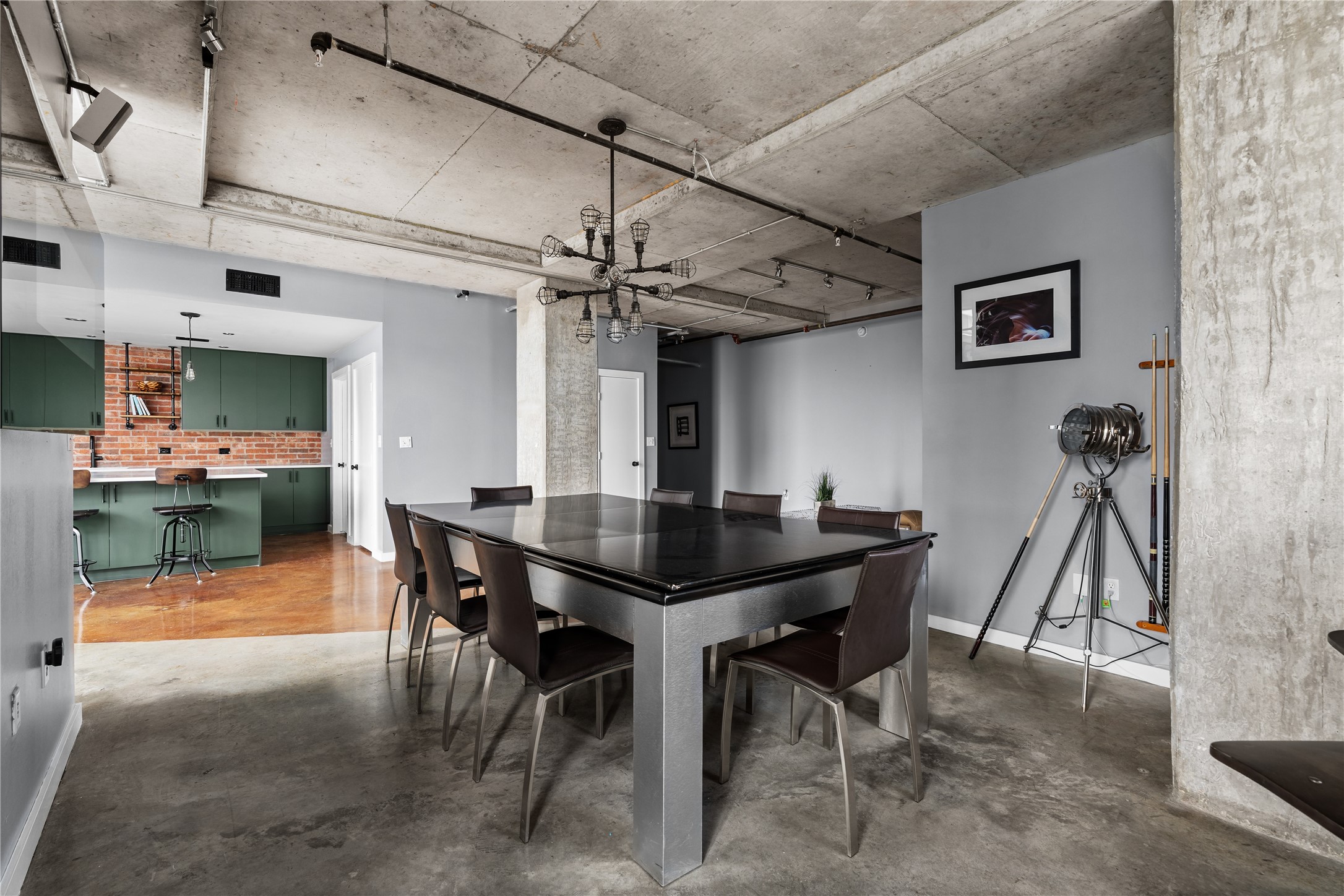 The dining area balances the lofts industrial architecture with a more intimate setting, offering generous space for entertaining while remaining connected to the kitchen and living areas.