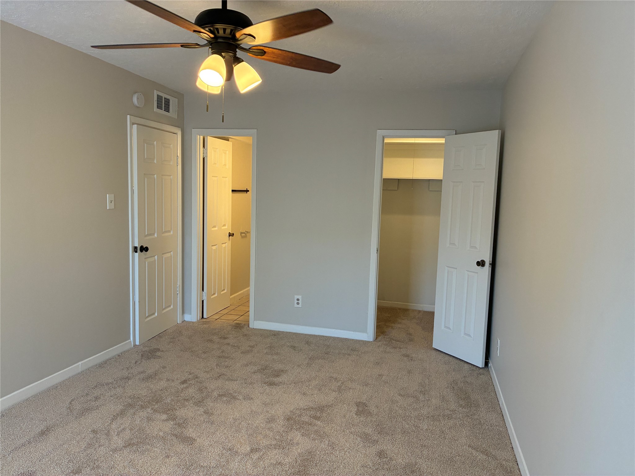 Primary Bedroom with doors to half bath and walk in closet