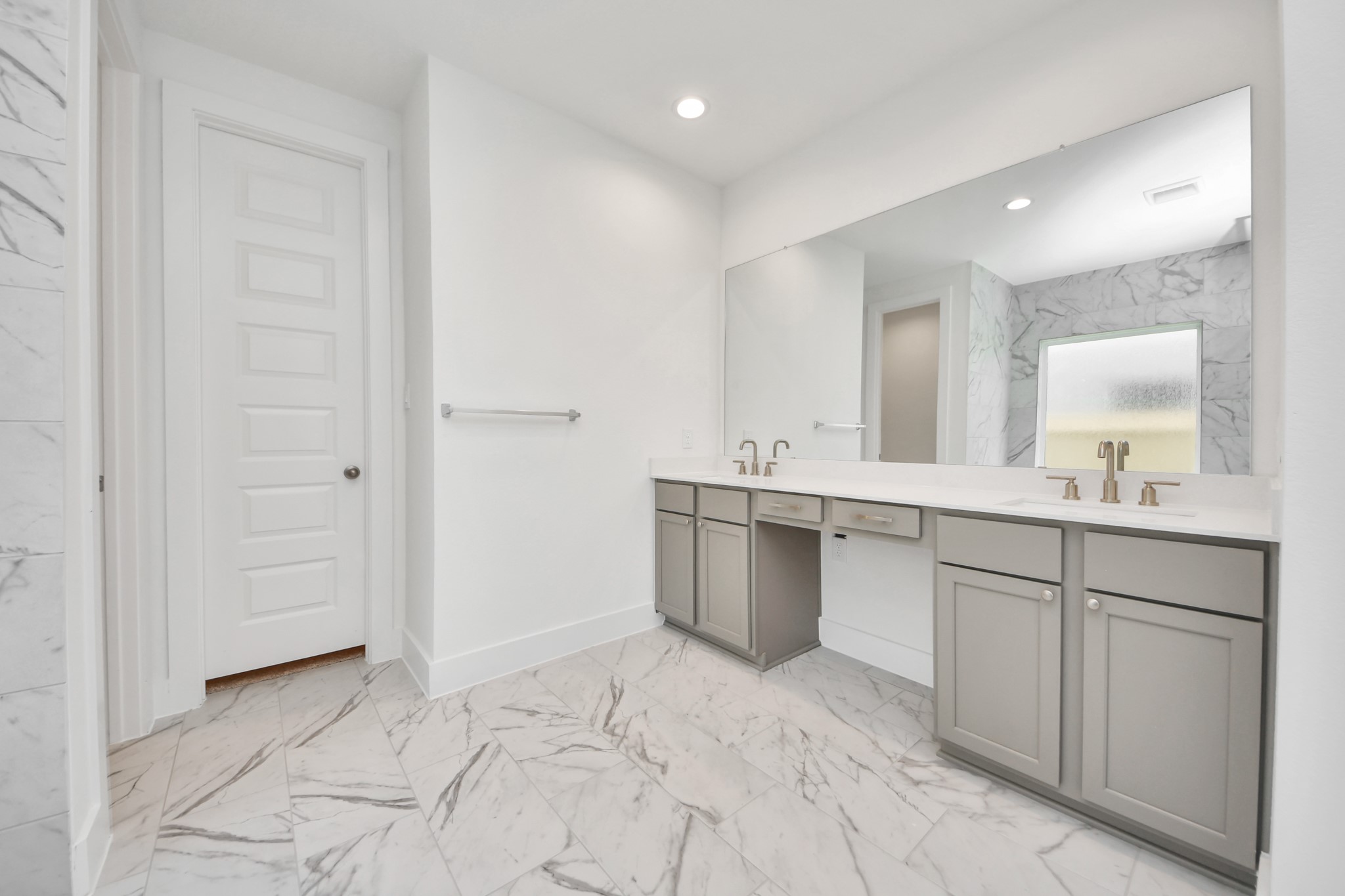 Escape to a spa-like oasis in this primary bathroom. Enjoy a walk-in shower with tile surround, a separate garden tub with custom detailing, and an elegant vanity featuring light countertops, modern hardware, and beautiful recessed lights. Experience luxury and relaxation in every detail. Sample photo of completed home with similar floor plan. Actual colors and selections may vary.