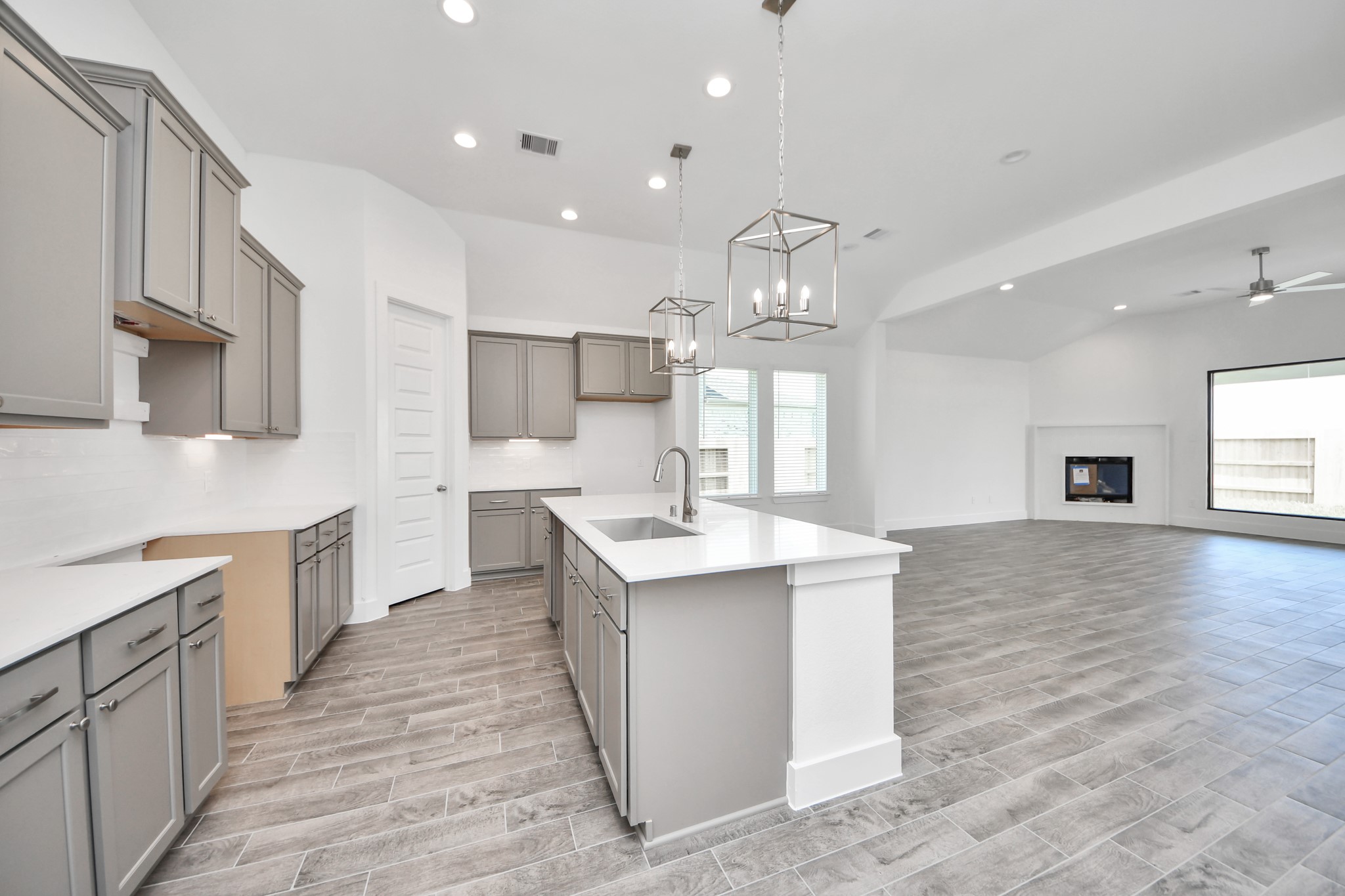 Step into a dream realized with this generously spacious kitchen! A massive granite island takes center stage, complemented by high ceilings and soft-close cabinets. The granite countertops, stainless steel appliances, sleek tile backsplash, and recessed lighting complete the elegant design. Sample photo of completed home with similar floor plan. Actual colors and selections may vary. Step into a dream realized with this generously spacious kitchen! A massive granite island takes center stage, complemented by high ceilings and soft-close cabinets. The granite countertops, stainless steel appliances, sleek tile backsplash, and recessed lighting complete the elegant design. Sample photo of completed home with similar floor plan. Actual colors and selections may vary.