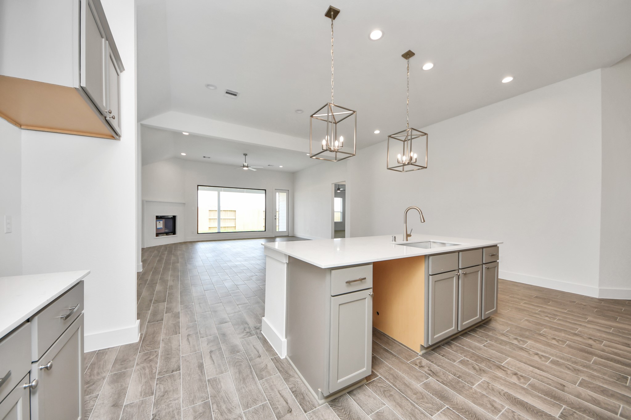 All of this overlooks your expansive family room, creating a perfect space for culinary delights and family gatherings. Sample photo of completed home with similar floor plan. Actual colors and selections may vary.