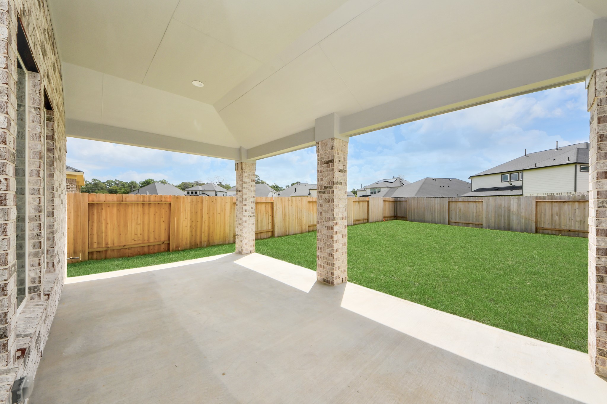 Experience outdoor living at its finest on this expansive covered patio, thoughtfully designed for BBQs and delightful outdoor dining. Sample photo of completed home with similar floor plan. Actual colors and selections may vary.