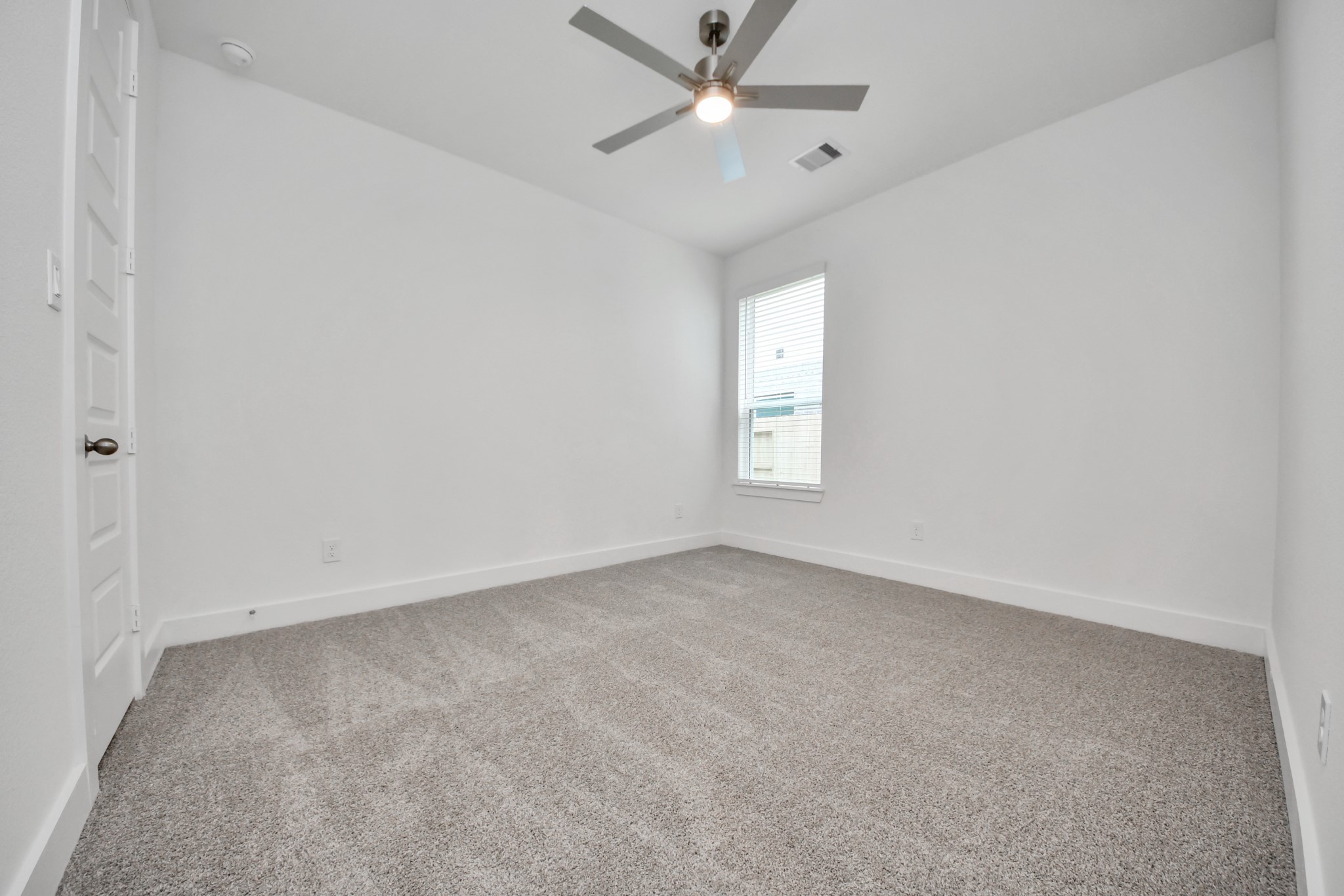 Secondary bedroom features plush carpeting, large windows that let in plenty of natural light, bright paint, and spacious closets. Sample photo of completed home with similar floor plan. Actual colors and selections may vary.