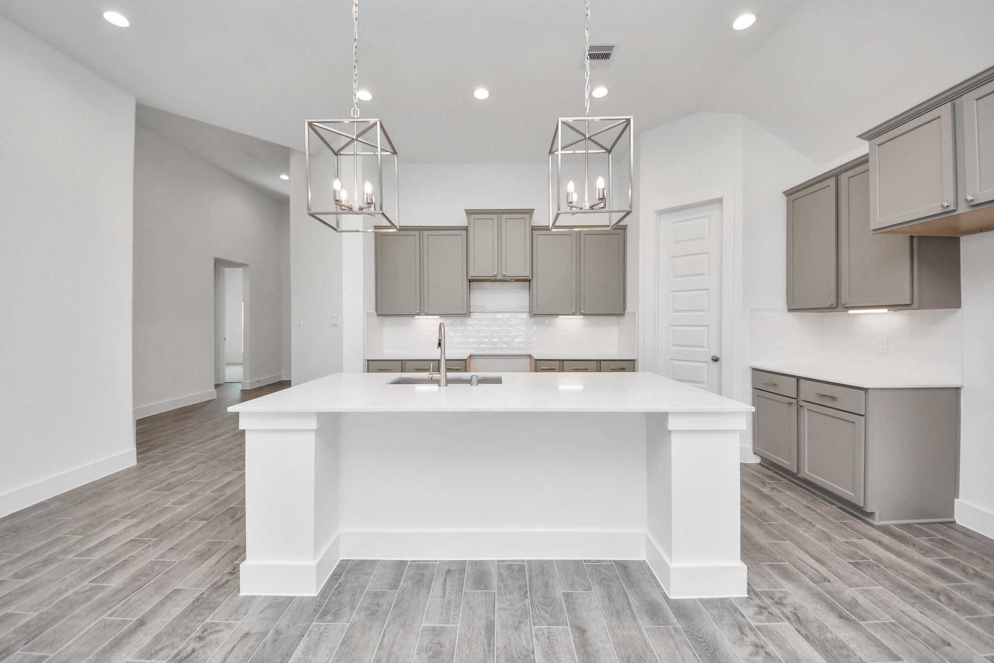 This kitchen is by far any chefs dream! This spacious kitchen features high ceilings, light stained wood cabinets, granite countertop, SS appliances, modern tile backsplash, recessed lighting, extended counter space, granite kitchen island, and space for breakfast bar, and a walk-in pantry all overlooking your huge family room. Sample photo of completed home with similar floor plan. Actual colors and selections may vary. This kitchen is by far any chefs dream! This spacious kitchen features high ceilings, light stained wood cabinets, granite countertop, SS appliances, modern tile backsplash, recessed lighting, extended counter space, granite kitchen island, and space for breakfast bar, and a walk-in pantry all overlooking your huge family room. Sample photo of completed home with similar floor plan. Actual colors and selections may vary.
