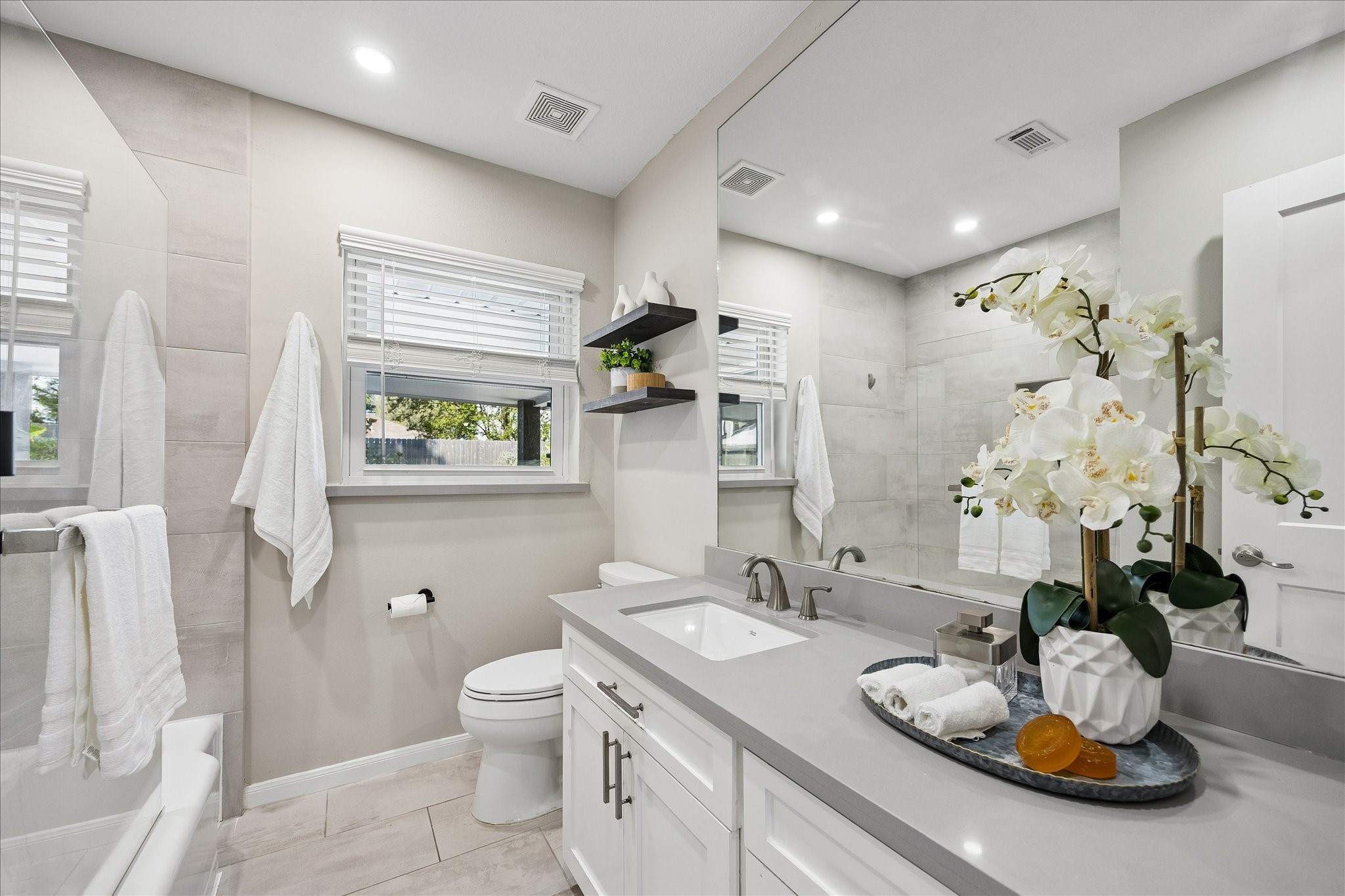 Spacious vanity, and polished finishes create a fresh, sophisticated feel.